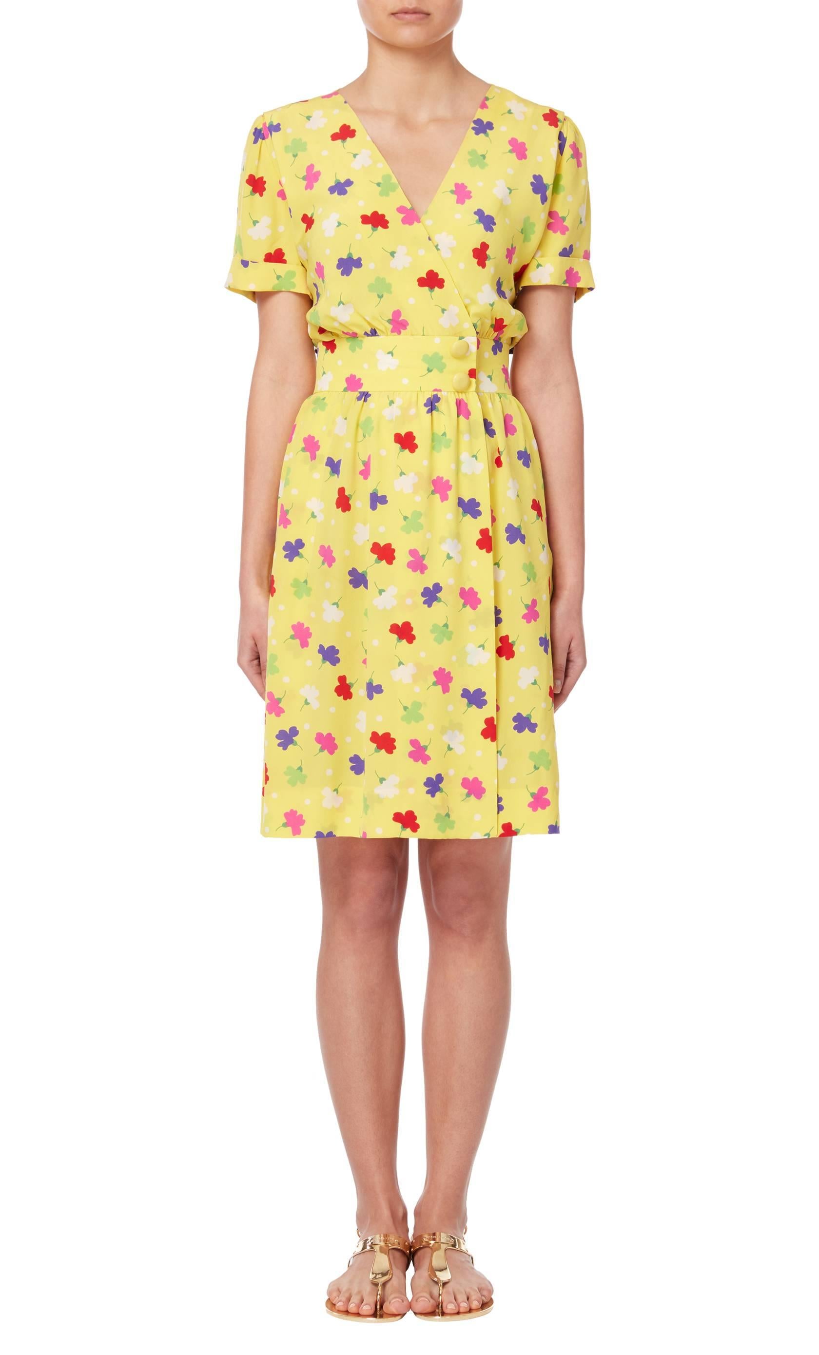 Haute Couture yellow silk floral printed day dress, circa 1988 by Givenchy. The short sleeved wrap dress features band and ruched detailing to the waist.