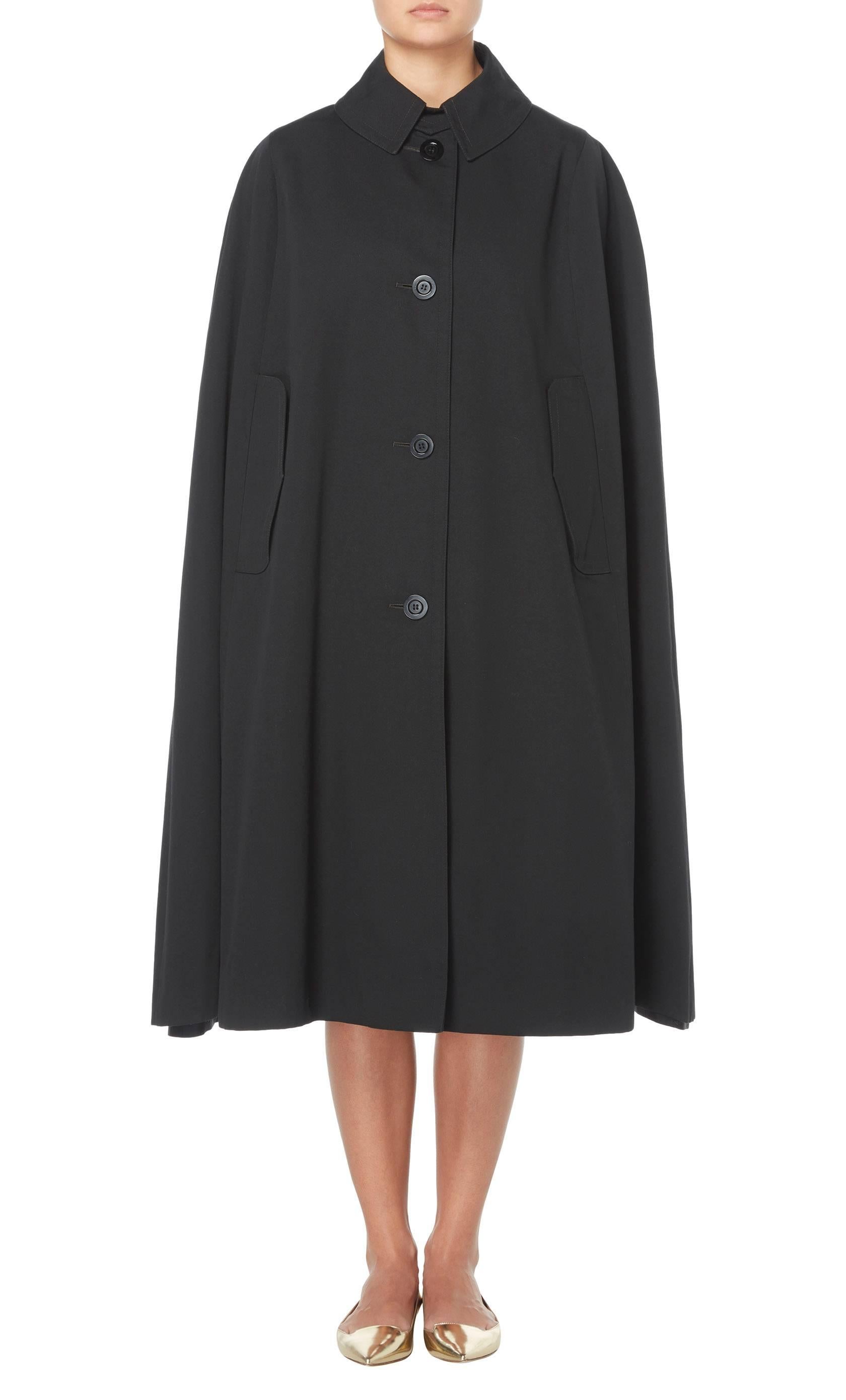 A practical piece for everyday, this Aquascutum black cape will lend a touch of chic to rainy days. Constructed in black cotton, the cape features a collar and buttons fastening to the front.

Constructed in black cotton
Featuring a collar and