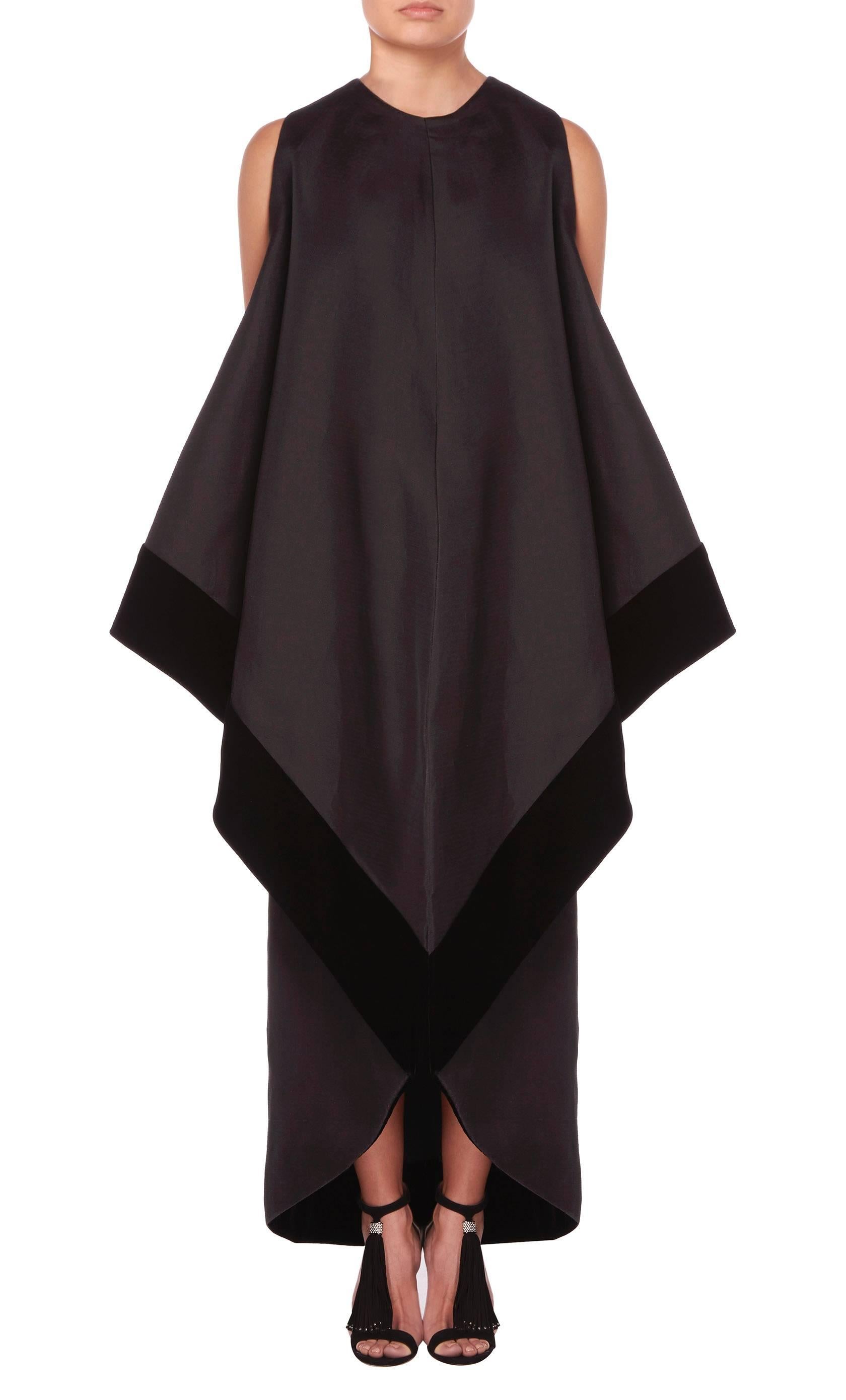 An incredible piece of Pierre Balmain haute couture, this gown is sure to make a statement on the red carpet. Constructed in black silk gazaar, the gown has a sculptural silhouette created with origami-style folds, with edges trimmed in contrasting