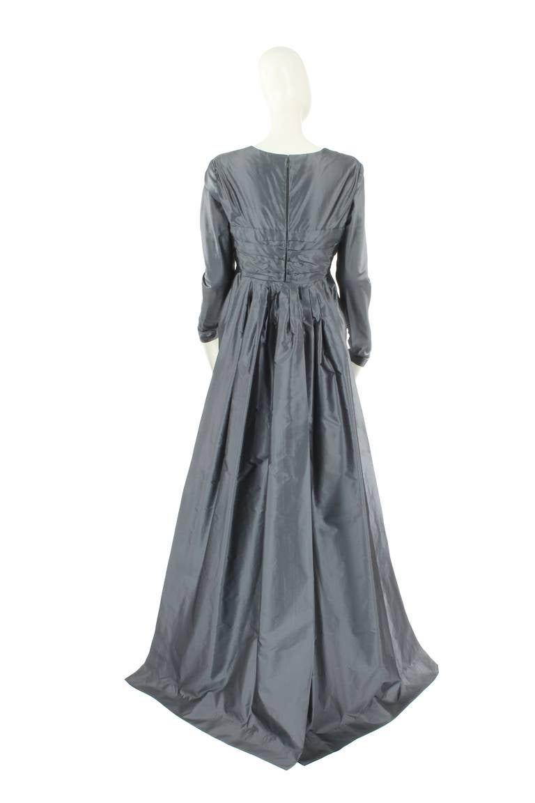 A stunning dress by Dior haute couture from the Autumn Winter 1988 collection, the first collection of Gianfranco Ferré for Dior, who was head of Dior from 1988 until 1997. The dress is crafted in a beautiful gunmetal grey silk taffeta and has all