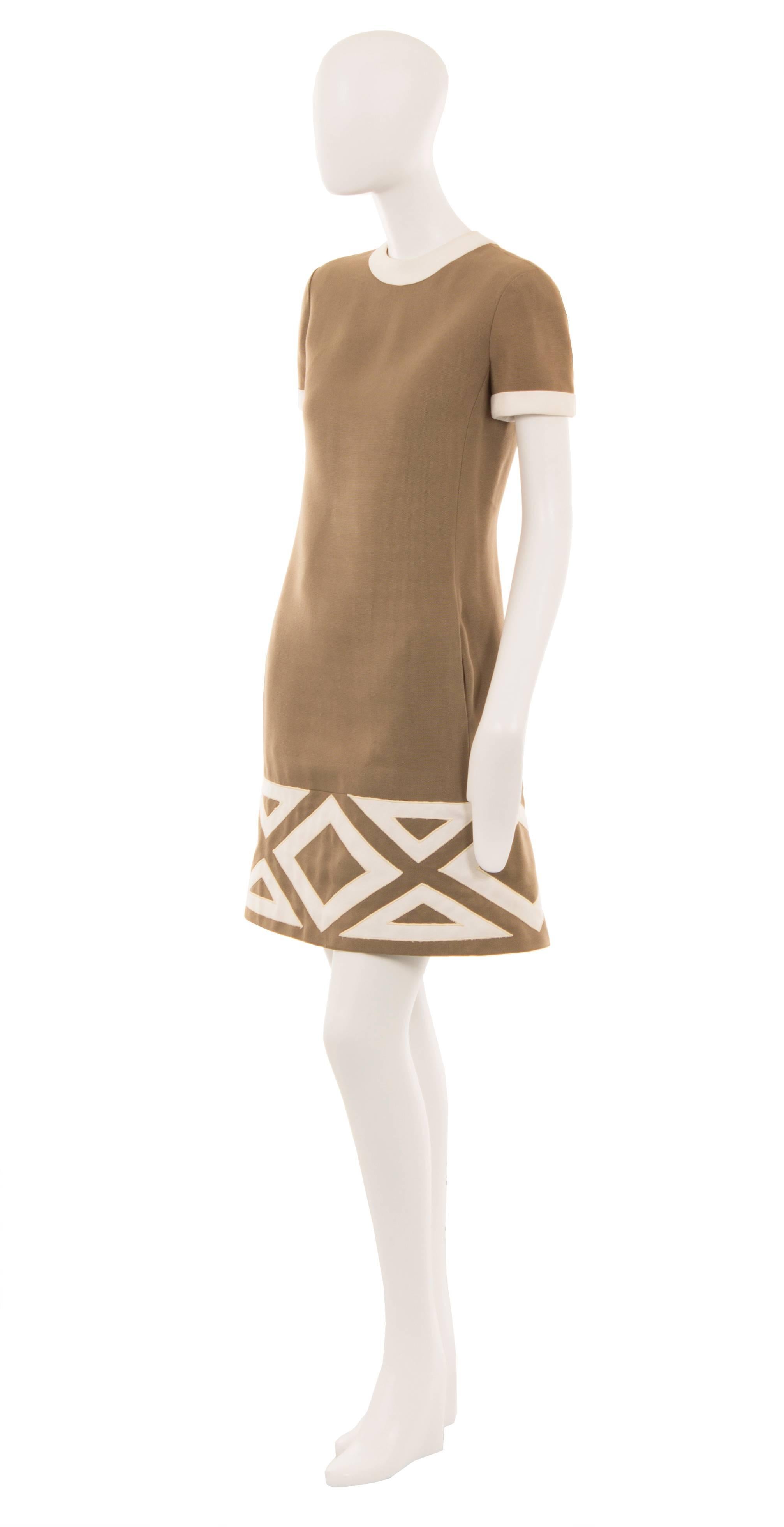 Super chic and easy to wear, this Pierre Cardin shift dress is constructed of brown linen and features an ivory trim to the neckline and short sleeves. The classic 60s silhouette is perfect for work or everyday and the dress features a bold diamond