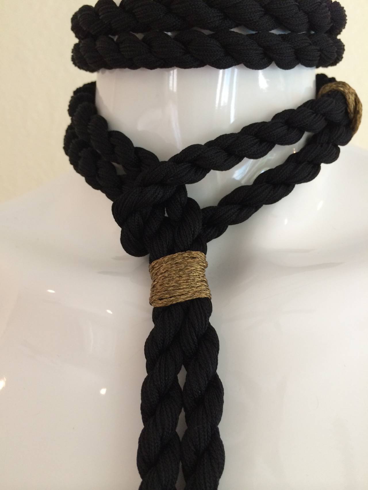 A Beautiful black and gold trim rope and tassel accessory from Yves Saint Laurent. Wear it as a necklace  or a belt. 34 inches long and the tassel alone is 6 inches. Excellent condition.