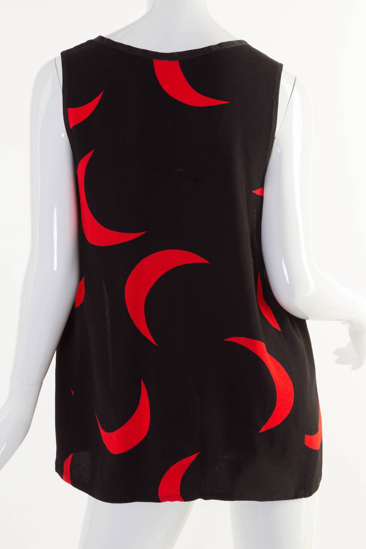 Vintage Saint Laurent black sleeveless with red moons open front vest. This is from the 1978 collection. 
Please see the last image with a moon dress from the 1978 YSL collection.
The fabric is unknown.
Measurements:
Bust:  30