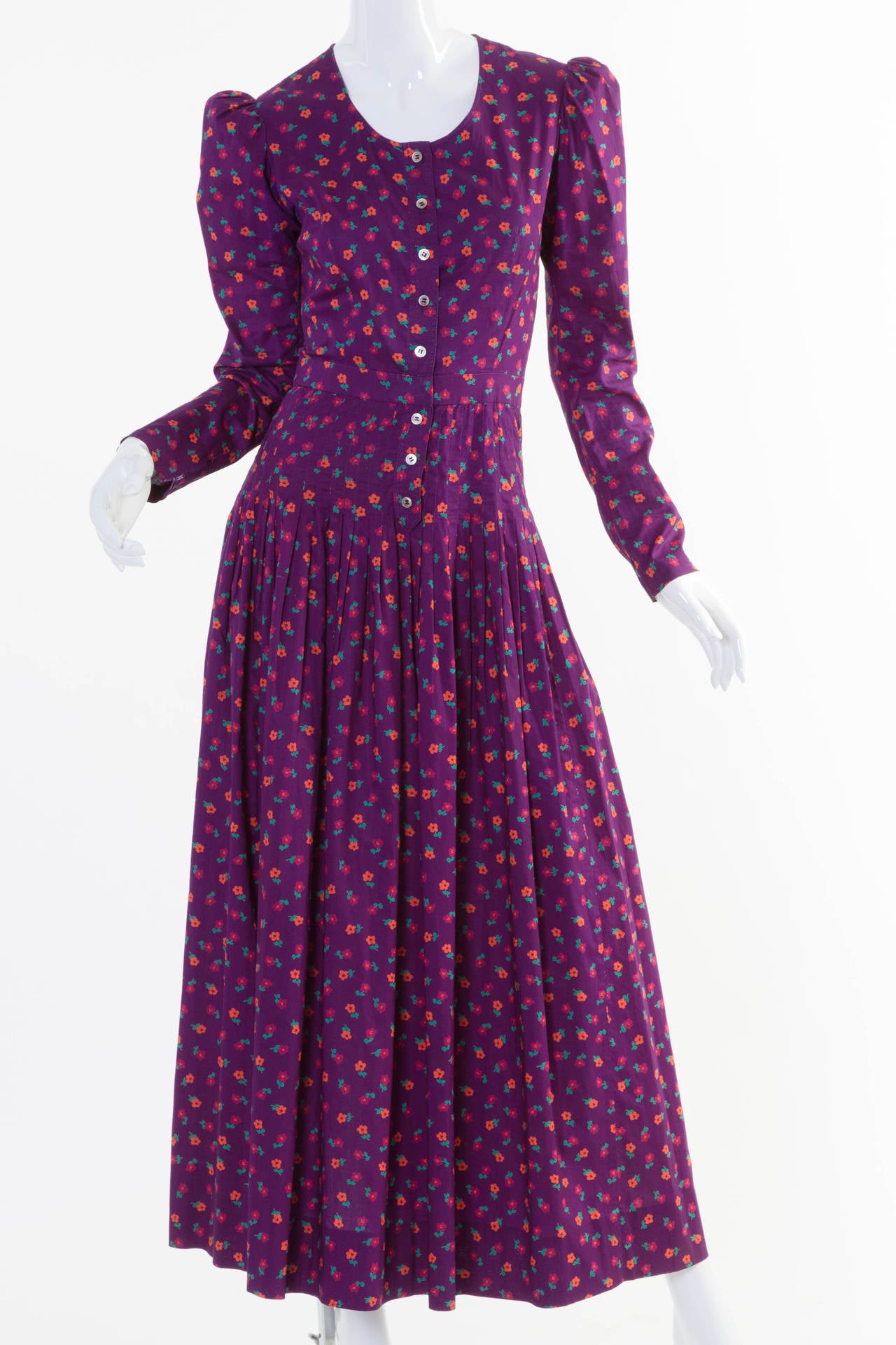 Vintage 1970s Yves Saint Laurent Rive Gauche gypsy style dress in very fine lightweight cotton with the smoothest finish in a deep plum or with floral sprigs in orange, cranberry, and green.
The purple color of this dress photographed slightly
