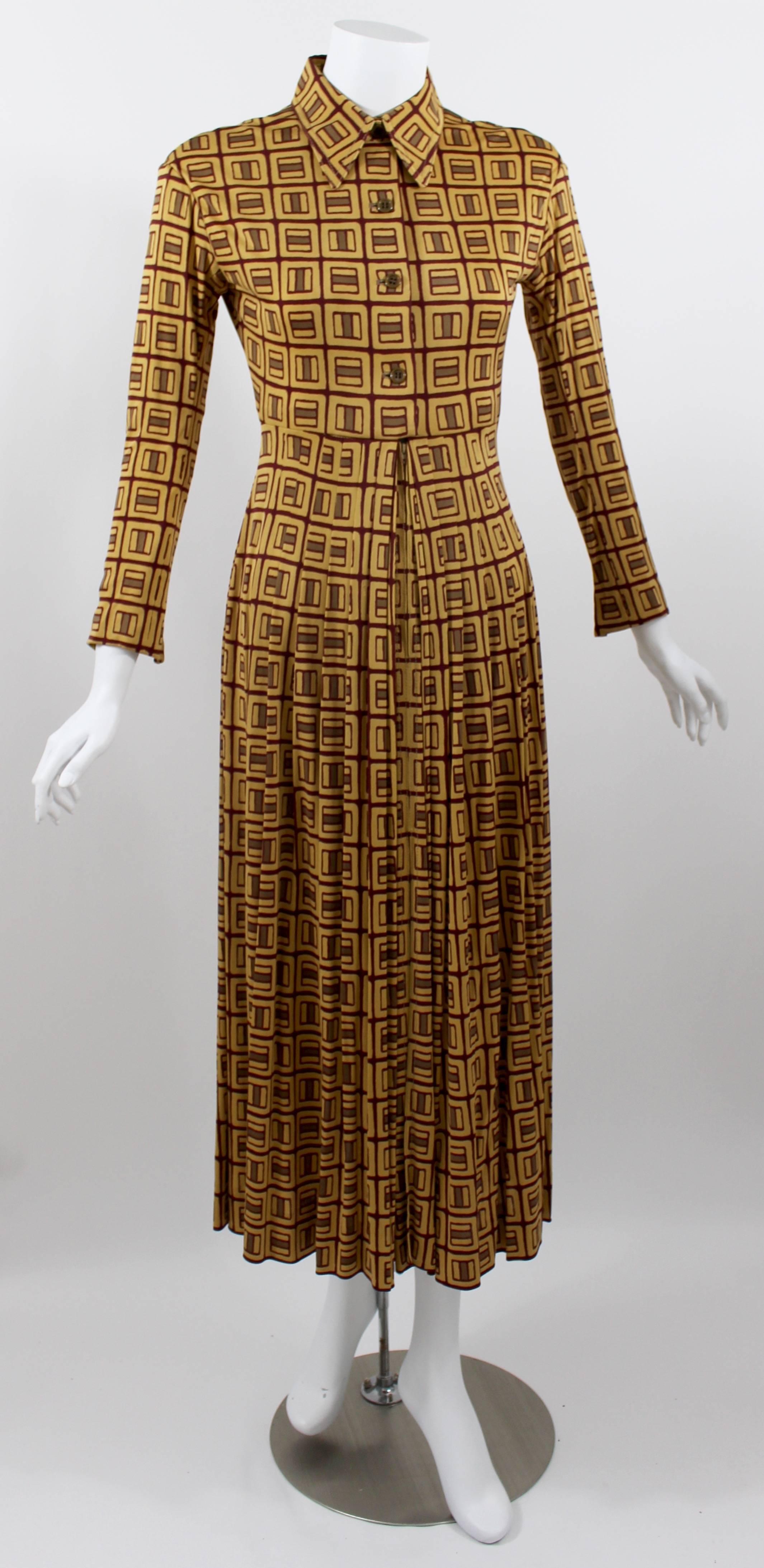A Galanos 1970s dress in a super fine silk jersey. 
Golden mustard yellow background with a burgundy and taupe print throughout.

The bodice is lined in a silk chiffon, the skirt portion is unlined.
The sleeves are fitted with five inch zippers