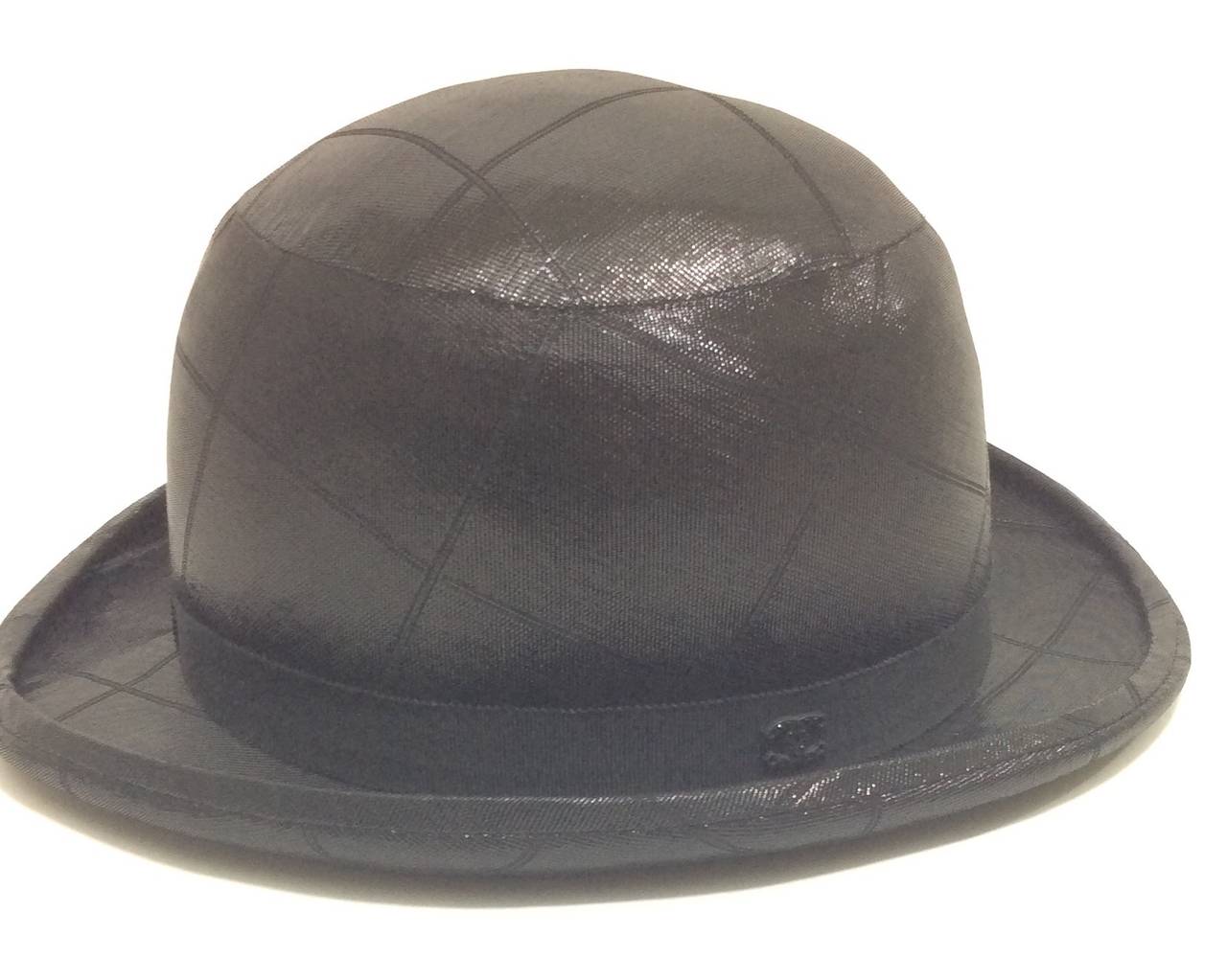 Metallic black Chanel bowler hat. Diamond stitching throughout. Double CC logo on hat band. The inside of the hat is lined in Chanel logo fabric. 
Made of 76% silk and 24% polyamide 
Size 56