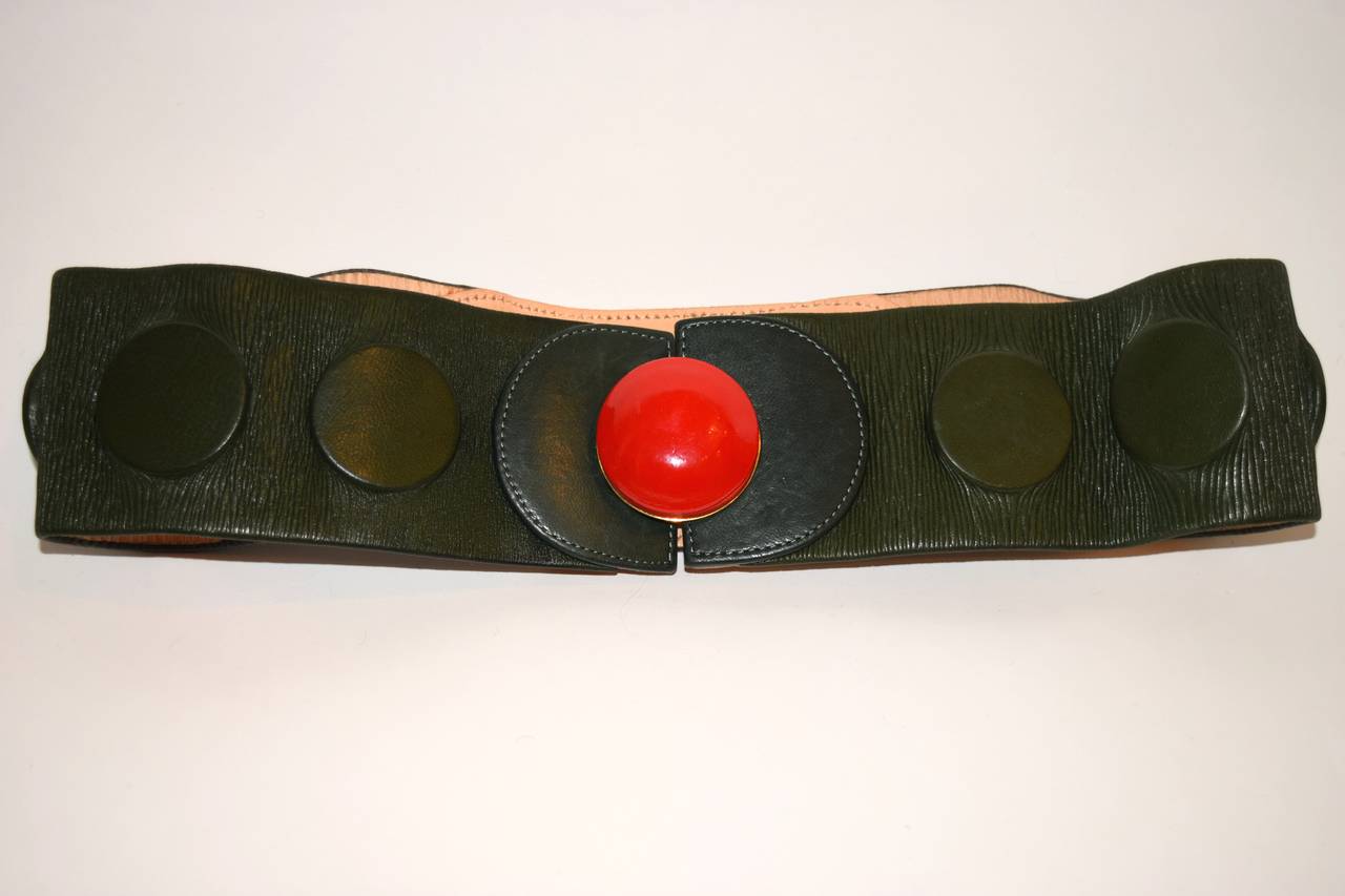 Vintage Chloe green leather belt, with a round bright red clasp. 
belt measures: 29 inches long. 2 3/4 inches wide.