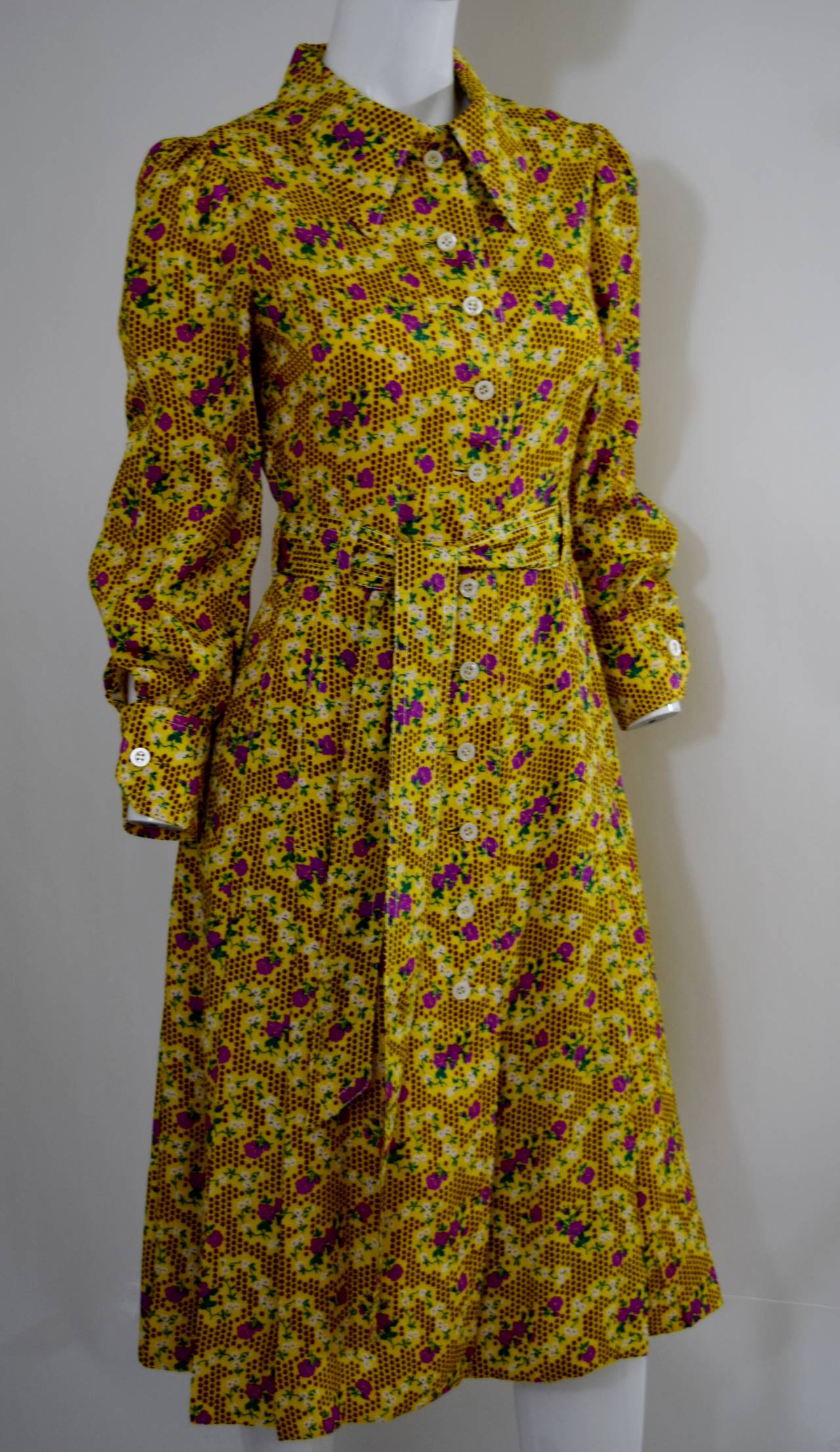 Galanos silk floral printed dress. Featuring a  collar and buttons on the front.Comes with a matching sash.

Fully lined in yellow silk