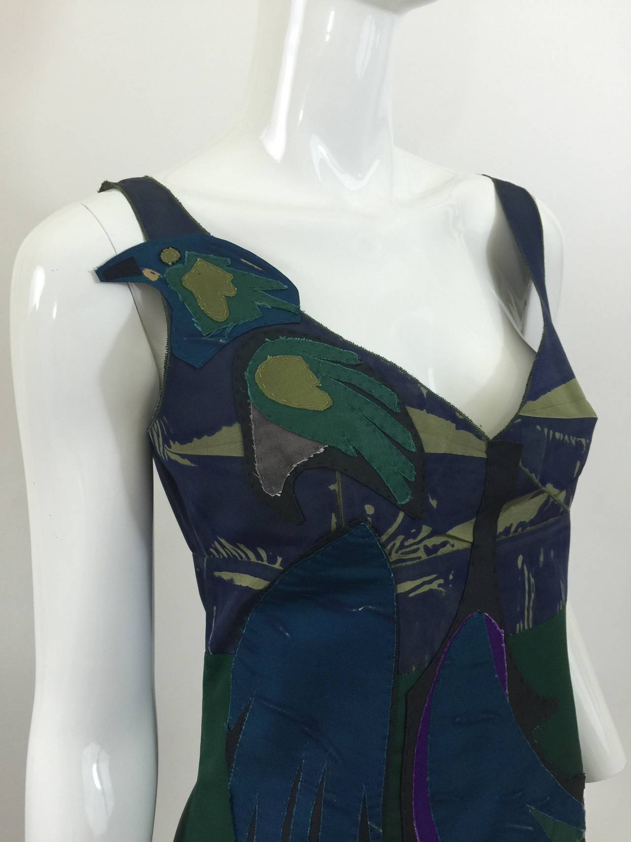 A delightful Prada dress from the spring 2005 collection. Featuring a parrot appliqué  on the front and gorgeous pleating in the center of the back . 

 Birds, said Prada, represent 