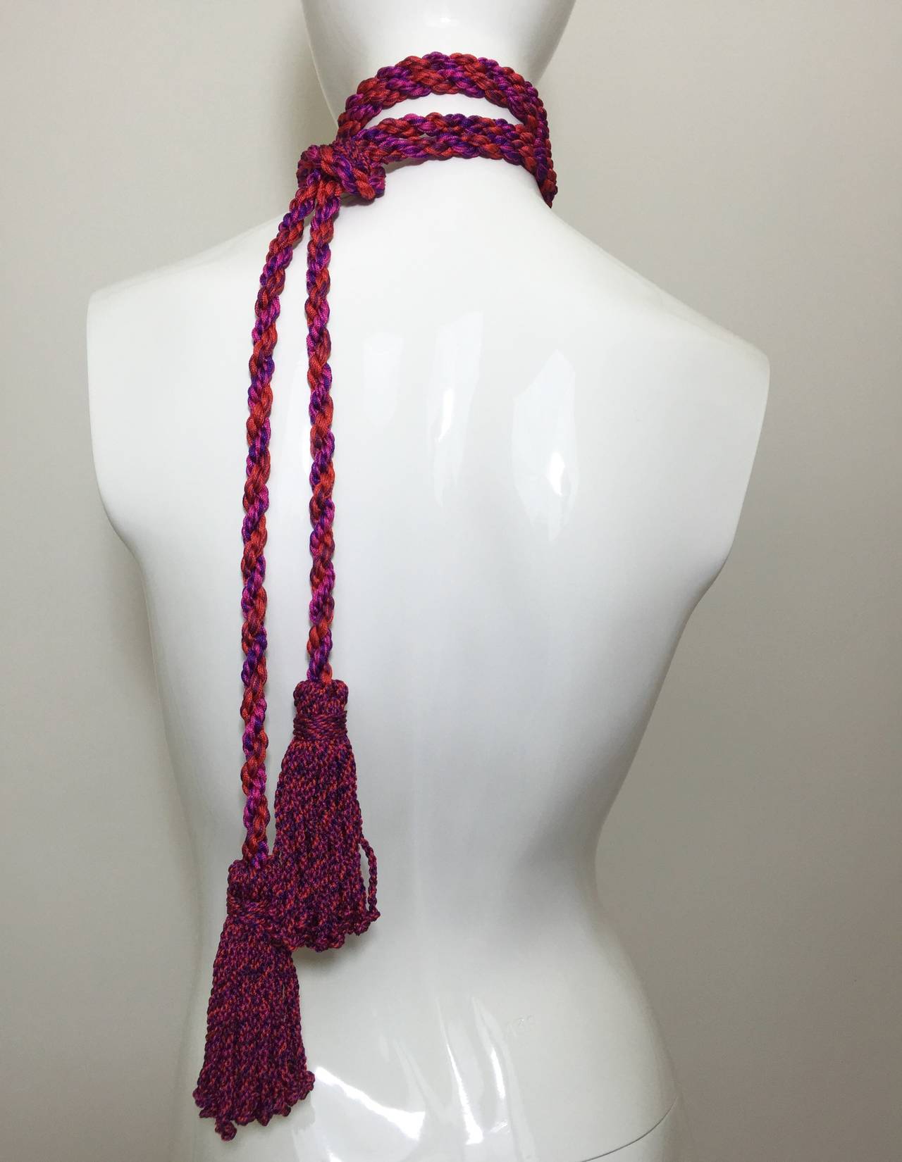 This  gorgeous  vintage YSL accessory is twisted silk rope with tassels in a brilliant color combination of hot pink, purple, plum and red. 
As a belt this will fit up to a 29 inch waist, as a necklace will fit all sizes.

The tassels measure 4.5