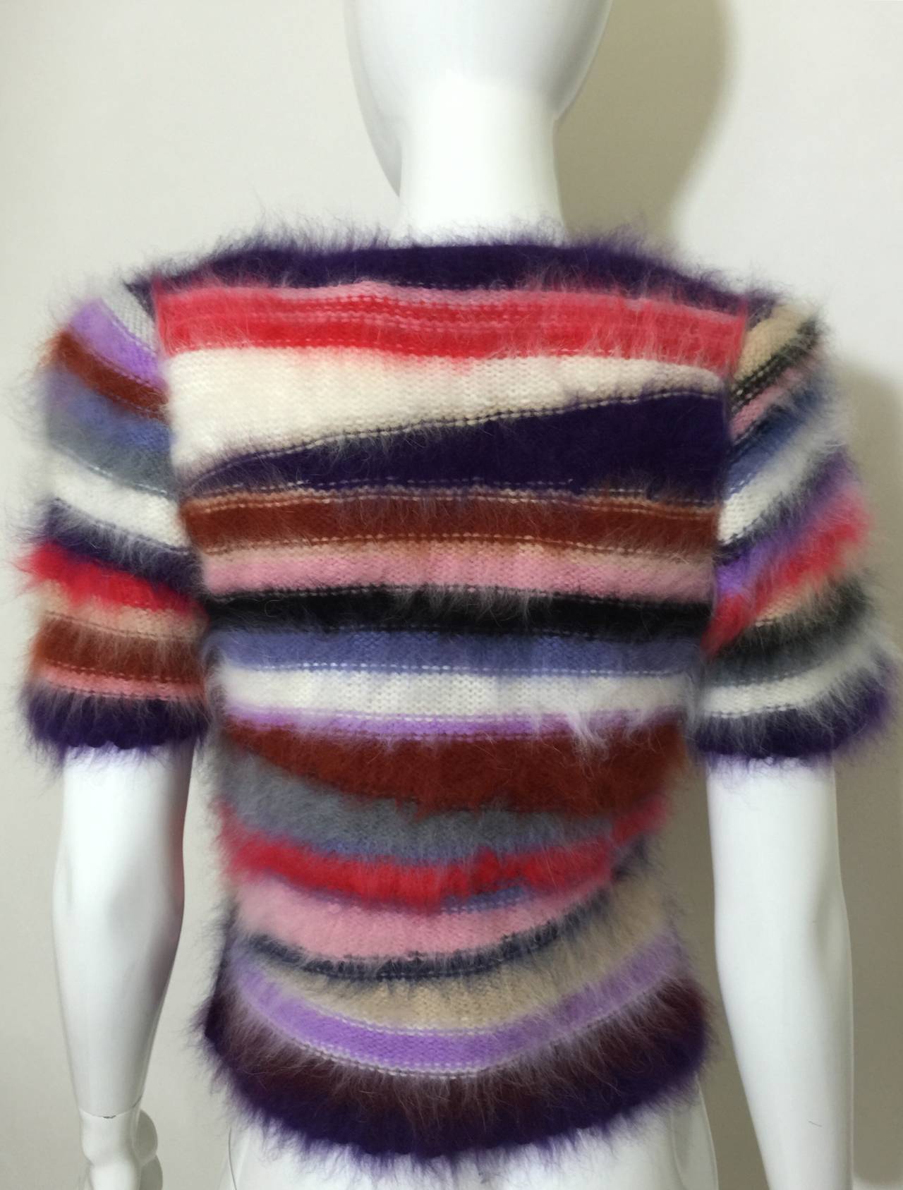 This short sleeve, v neckline rainbow sweater is full of color and texture. 
From the 1980s, retailed at Neiman Marcus.
Excellent condition.
Please check the measurements provided and compare with your own measurements for the best possible fit!