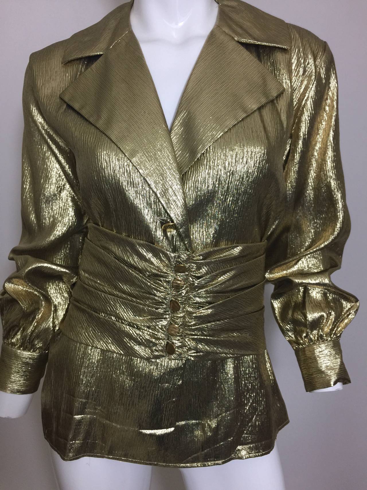 This is a vintage YSL lightweight gleaming metallic gold lame' blouse with a matching wide five button ruched belt 
The blouse has a relaxed fit with a 2 gold textured button front, and a single button cuff.

Excellent condition.
Please check