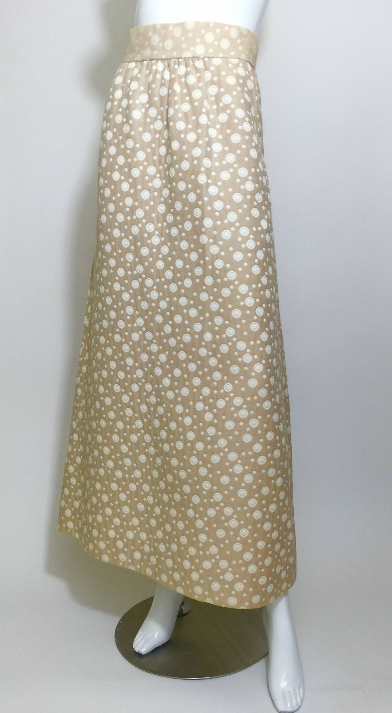 Ivory and Linen dots and circles patterned maxi skirt.
Two front hidden slit pockets. waistband is lined and 
Back metal zip with hook and eye closures.

The skirt is labeled with a custom Bergdorf Goodman Tag, with the clients name and date.