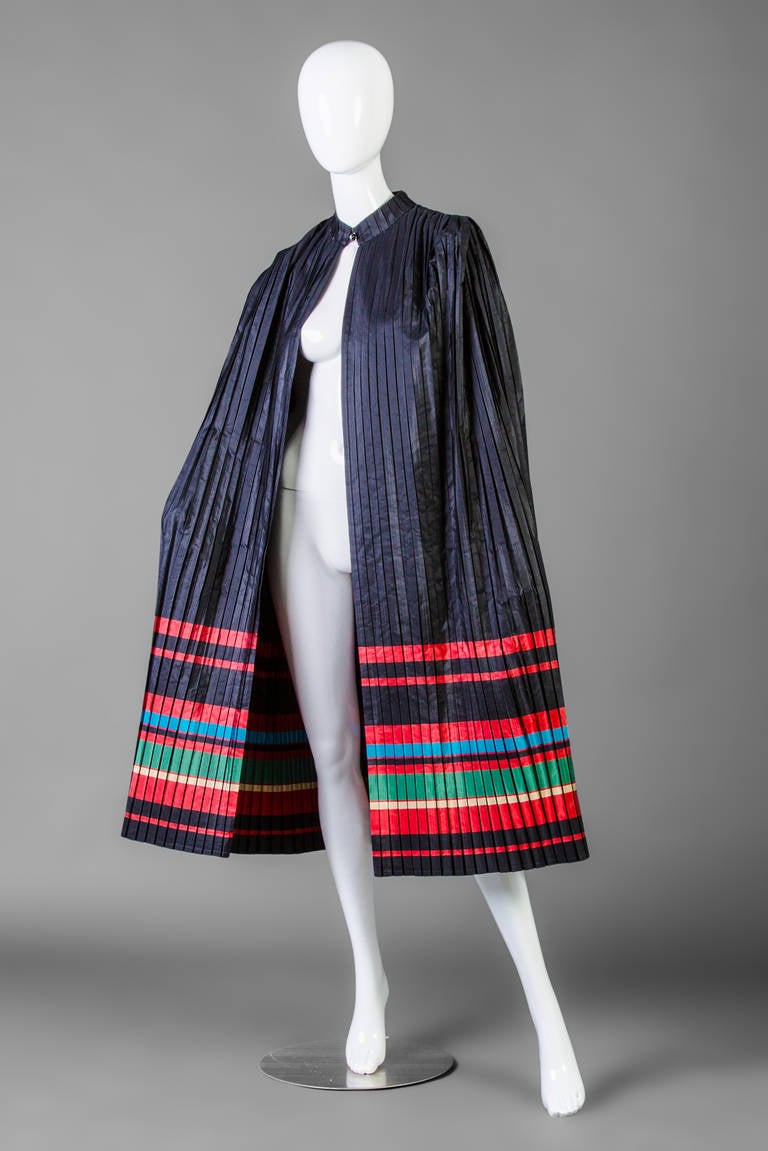 Christian Dior cape and dress: Cape is a pleated silk with crystal button closure and stripe bands in red, green gold and blue.
cape shoulders measure 17