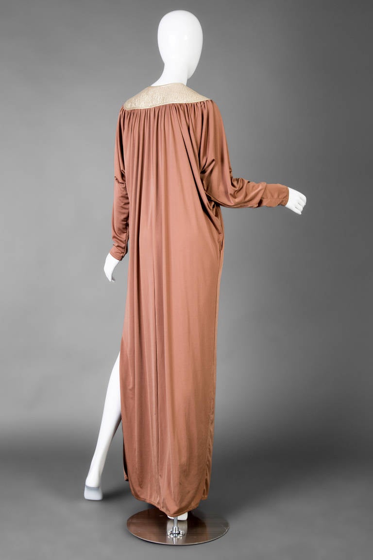 Glamorous 1970's Caftan designed by Bill Tice and retailed at Saks Fifth Avenue.
Features broad shoulders, with a quilted gold metallic yoke that frames the back of the neck and front of the shoulders. 
Deep v neck, push up sleeves and beautiful