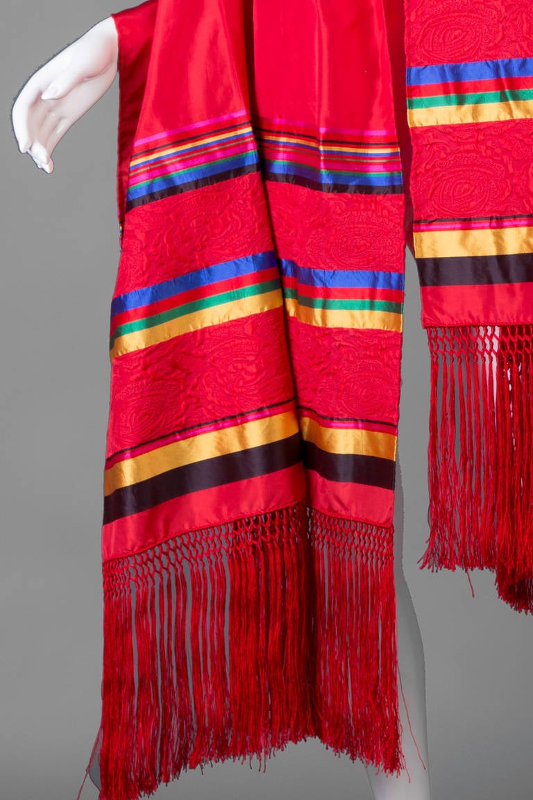 Yves Saint Laurent huge vintage fringe shawl.
This shawl is outstanding!
In a brilliant shade of red this shawl measures six feet in length with another ten inches of fringe.
The fabric content tag has been removed however it is 100% silk. 
See