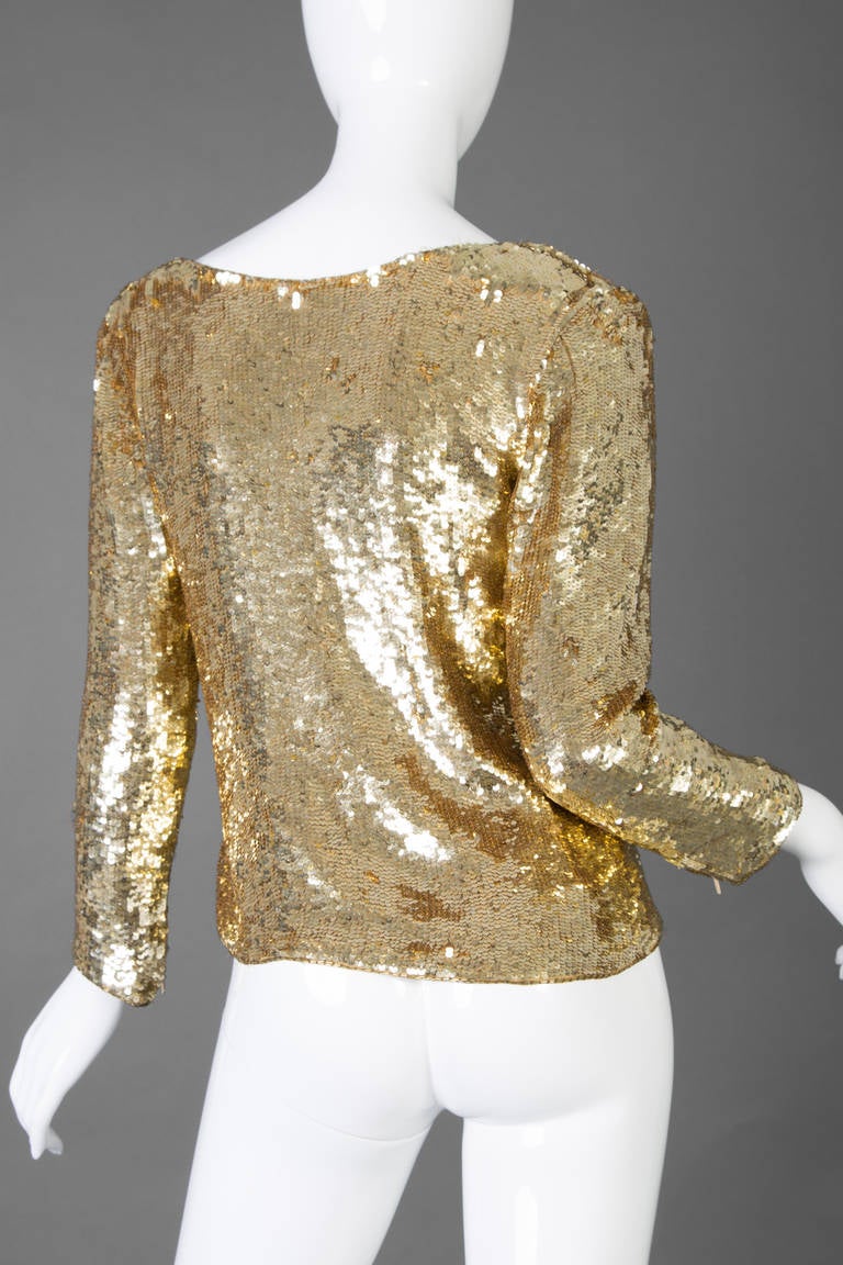 Saint Laurent Vintage Gold Sequin jacket. Buttons up the front on an angle with five crystal embellished buttons. Zippers at the end of the sleeves.