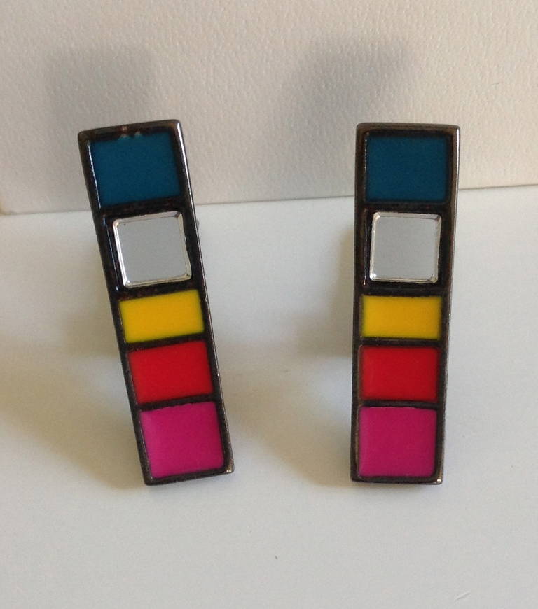 YSL Yves Saint Laurent Color-block Earrings
Vintage and in  lovely condition
Clip on backing signed YSL
The earrings have 5 colors:  4 of the squares are enamel and the second  square is a mirrored crystal.
They measure just under  1 1/2 inches