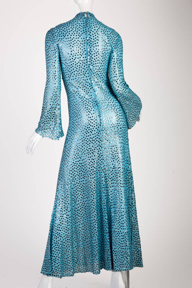 Vintage Mollie Parnis Boutique ice blue metallic lurex gown, covered in silver sequins, mock turtleneck, fitted long sleeves that end in a bell shape, fishtail hem, metal zipper on back. Absolutely beautiful and in Excellent Vintage Condition!
