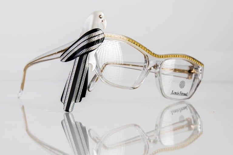 Rare and collectable,  Louis Feraud  French designer frames, made in France in the late 1980s .The frames are clear in a modified cat eye shape and are adorned with yellow rhinestones across the top .The parrot is removable, and can be worn with or