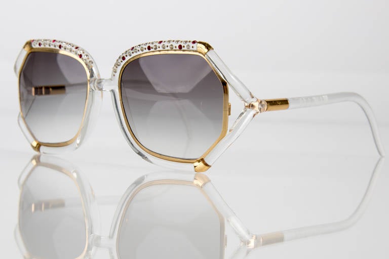 Ted Lapidus sunglasses with clear frames trimmed in gold featuring rhinestone crystal detail across the top.