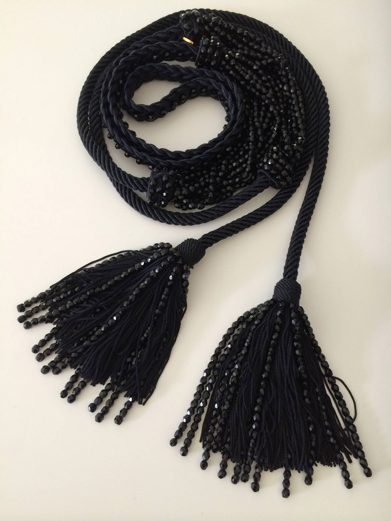 Gorgeous Yves Saint Laurent Necklace with beaded tassels
This necklace has so many possibilities! Worn in front, or  for a backless dress, a belt.... its truly beautiful.
The necklace measures approximately 38 inches, the tassels alone measure 4