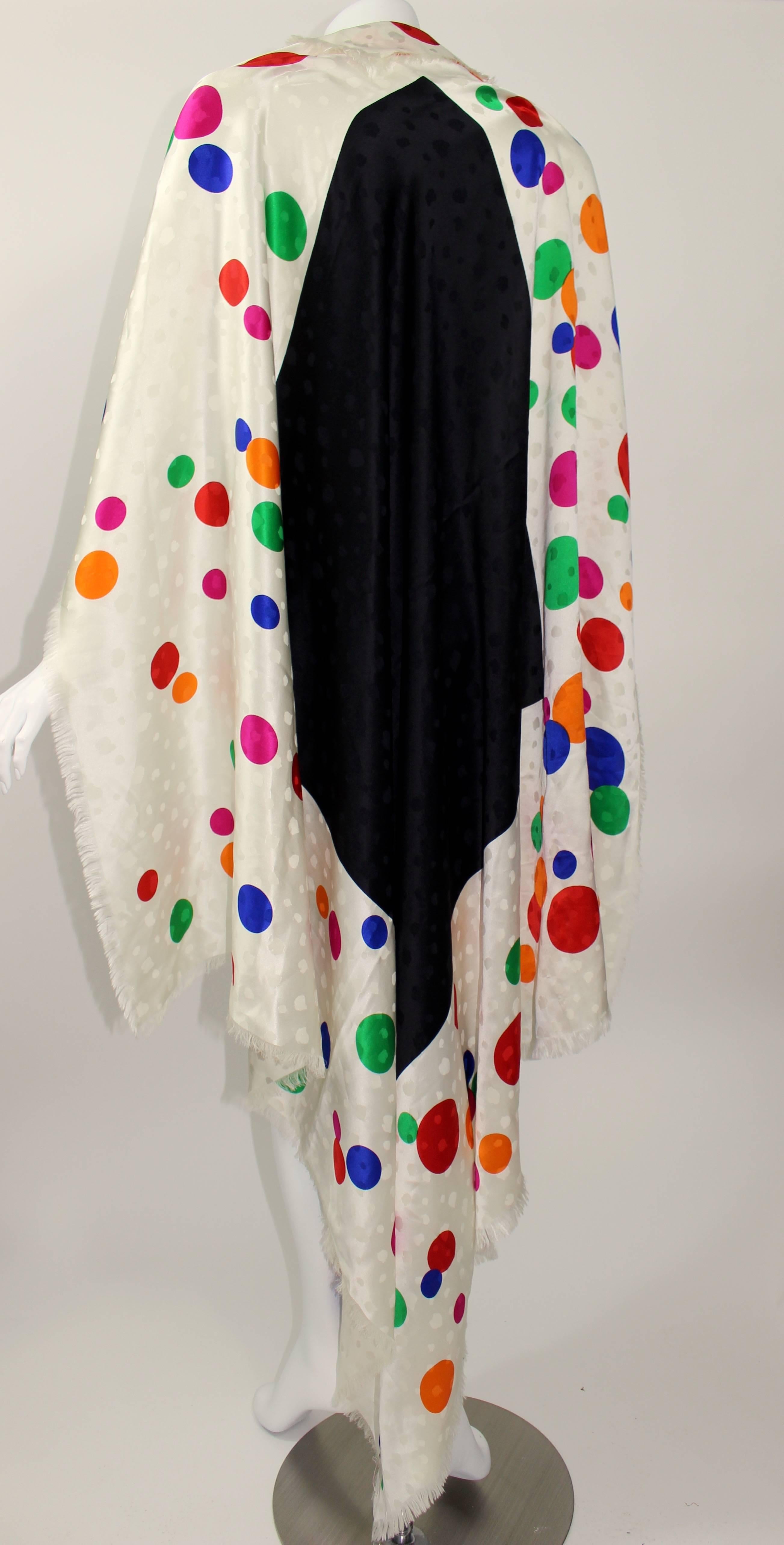 A beautiful and huge colorful vintage silk shawl from Saint Laurent. 
So many details of color, pattern and texture. Subtle flocked detail noticed most when the shawl catches the light. 
The center is black and the outer is ivory with all different