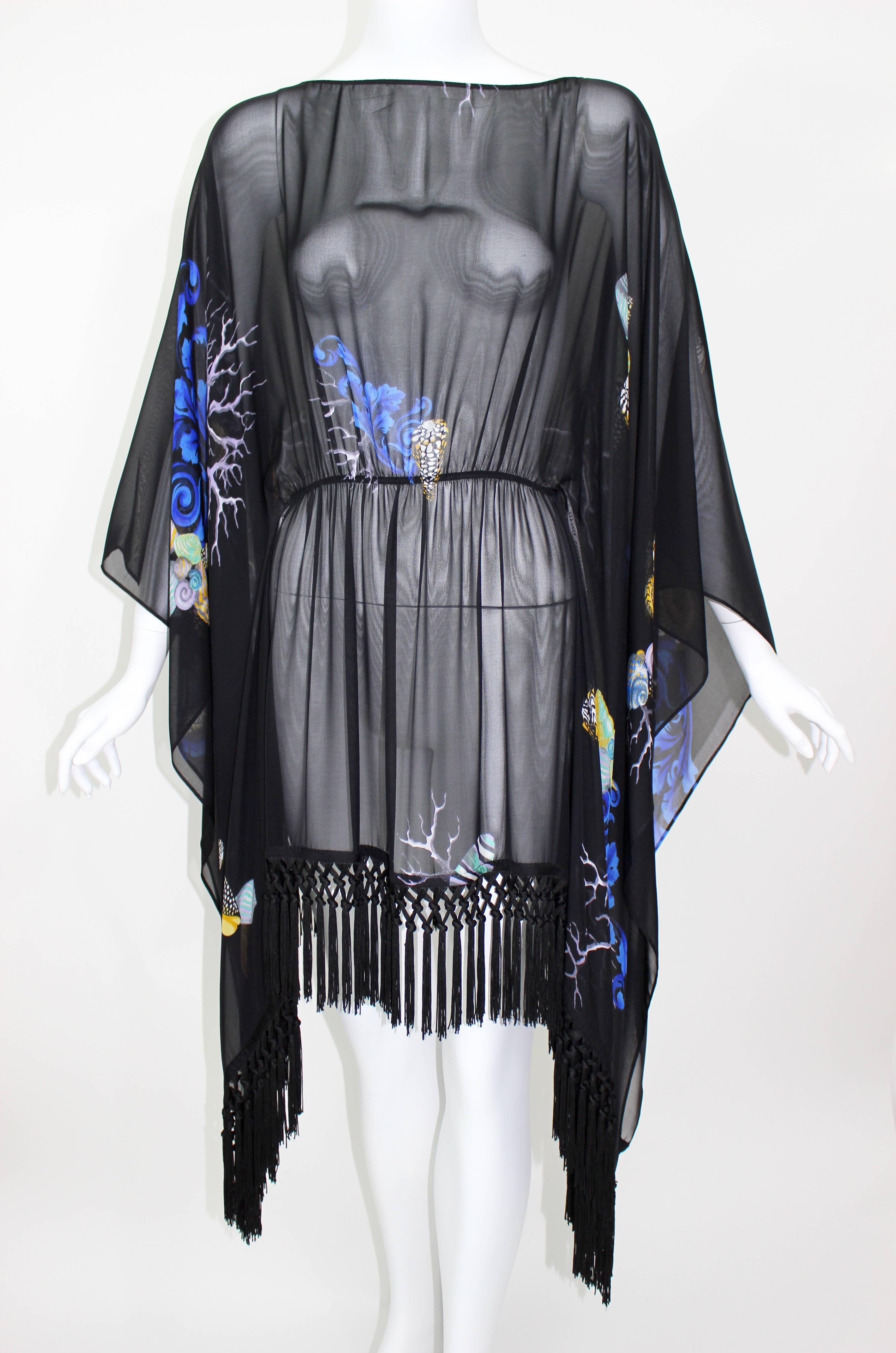A recent Versace Collection sheer silk top with knotted silk fringe trim.
Kimono style sleeve.
Seashell and Coral Motif Print.
Excellent Condition.

Photographed on a size 4 mannequin

Measurements:
Bust: 34 inches
Waist: 26 inches
Length