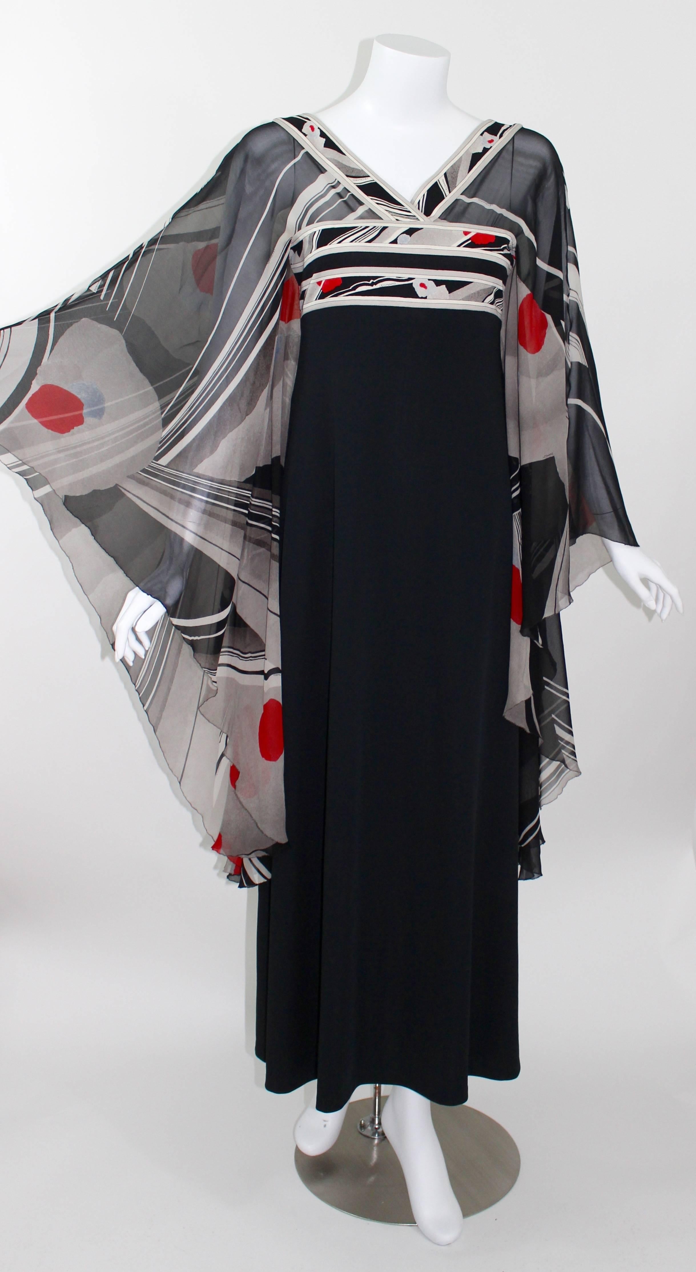This is a fabulous 1970s Leonard Paris caftan style maxi dress. 
The bodice of the dress is sheer printed silk chiffon with an abstract floral print. Beautiful, huge  long draped angel sleeves in sheer silk chiffon. 
The body from under the bust