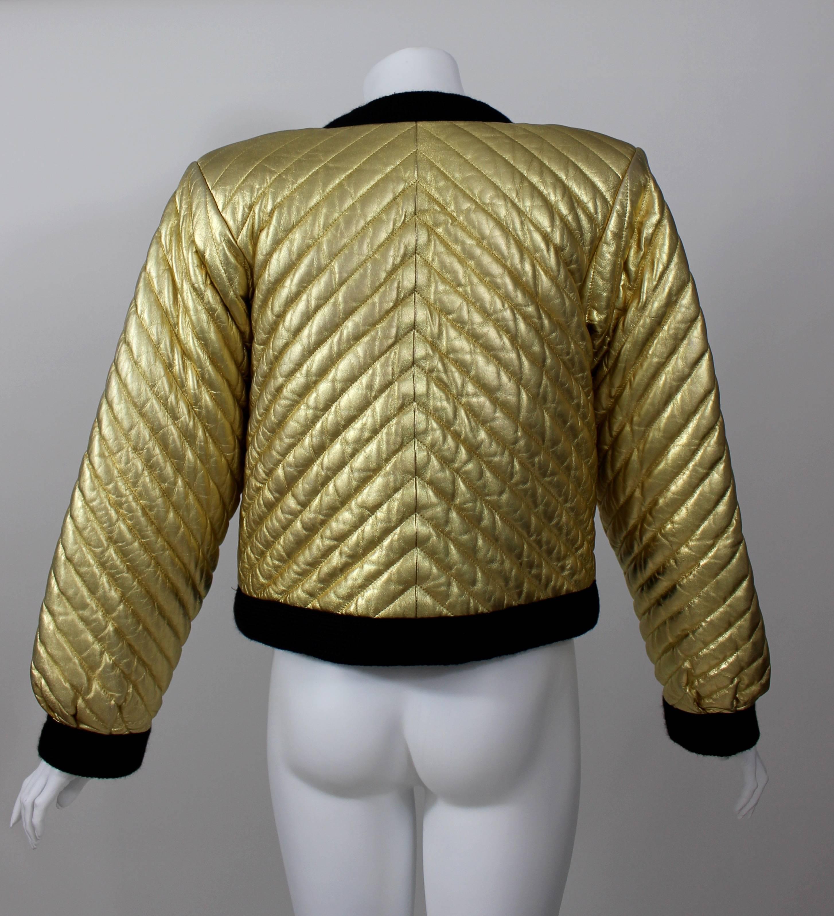 A Fabulous Vintage Yves Saint Laurent bright gold bomber jacket. Made of soft quilted leather. Trimmed in a textured wool, and lined in soft cotton.

Size: 34

Measurements:
Shoulders 16. 5 inches
Jacket length: 20 inches
Sleeves: 23.5