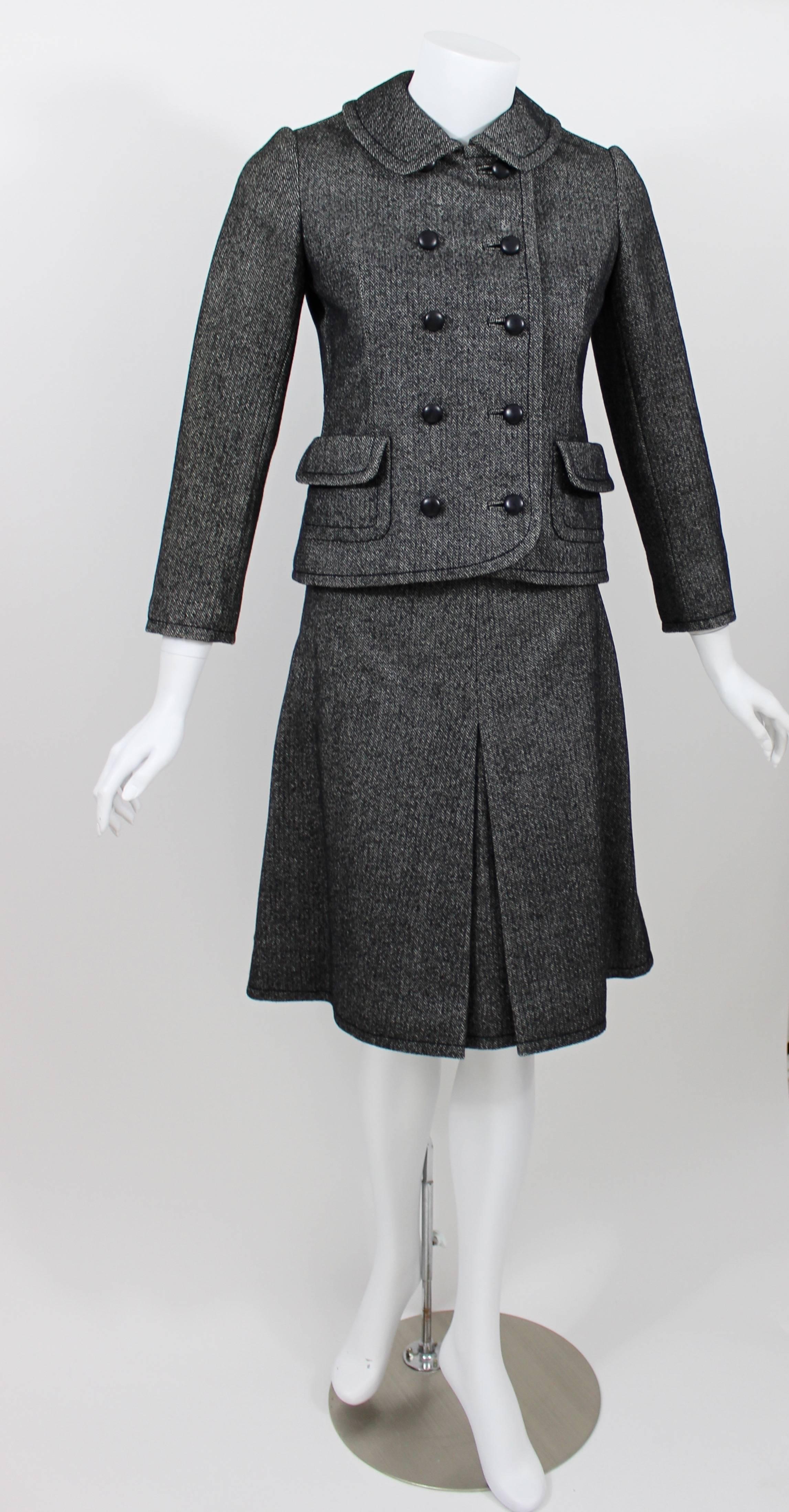 A vintage skirt suit from Bergdorf Goodman circa 1960s.
Wool herringbone.
Peacoat style jacket
Skirt is knee length a line with a front inverted pleat.
The skirt has metal zipper closures on each side.
Fully lined.
Excellent