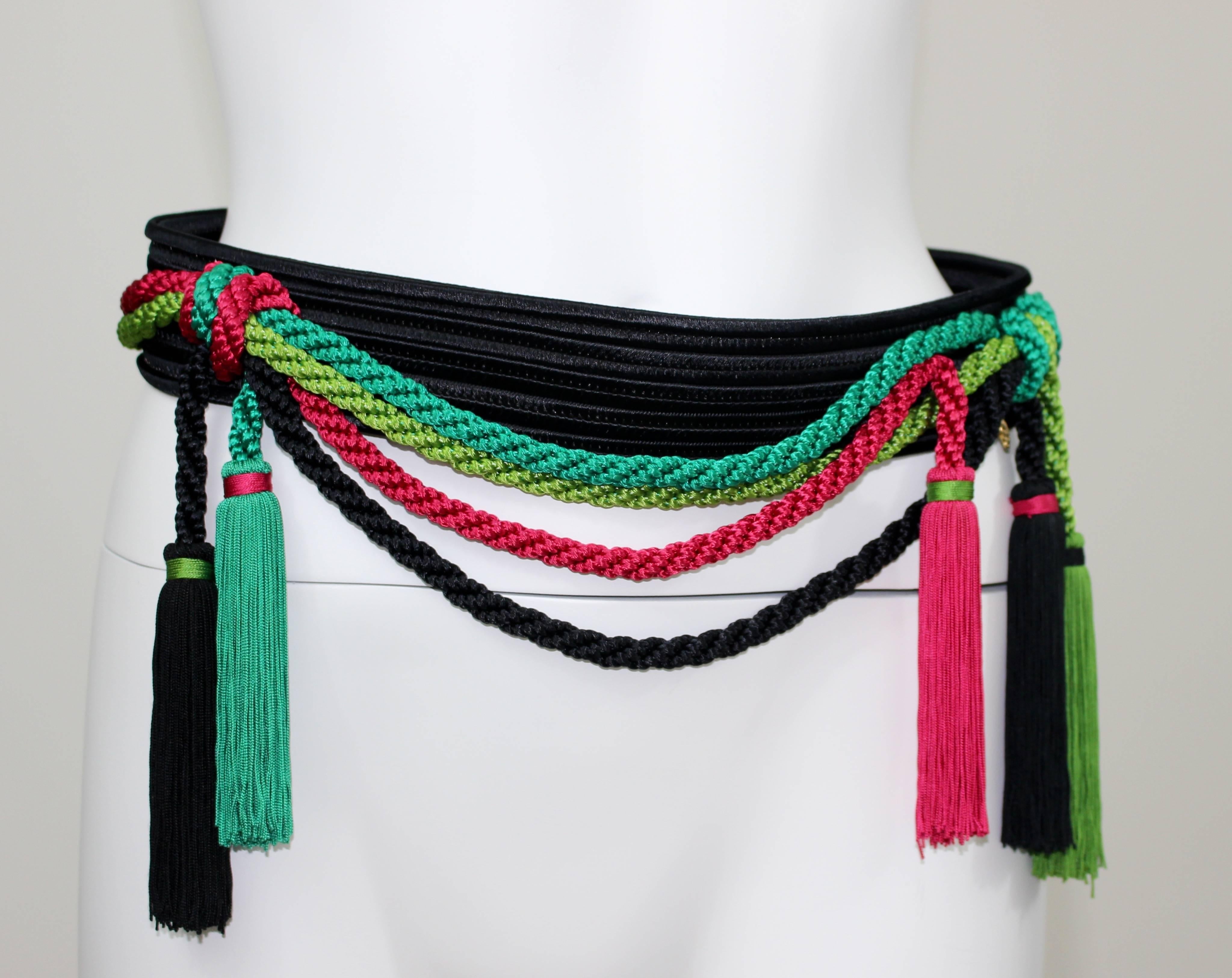 Vintage Yves Saint Laurent Russian rope and tassel belt.
Black with ropes in turquoise, chartreuse, and hot pink. 
Five tassels!
Single hook closure in the back.
Signed YSL on the gold name plate that is sewn to the