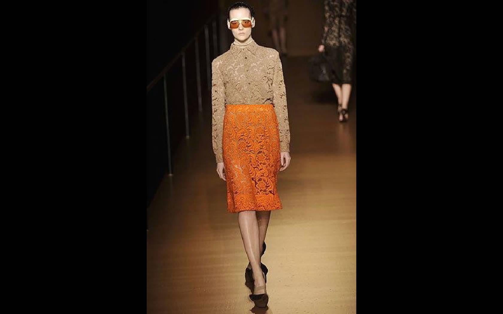 F/W 2008 Orange Guipure lace skirt by Prada.

The skirt is unlined and closes at the left side with four snaps and a large hook and eye. 
The waist is finished with  grosgrain ribbon. Comes with a silk Prada slip. 

Size estimate: S
Size: 36
Waist: