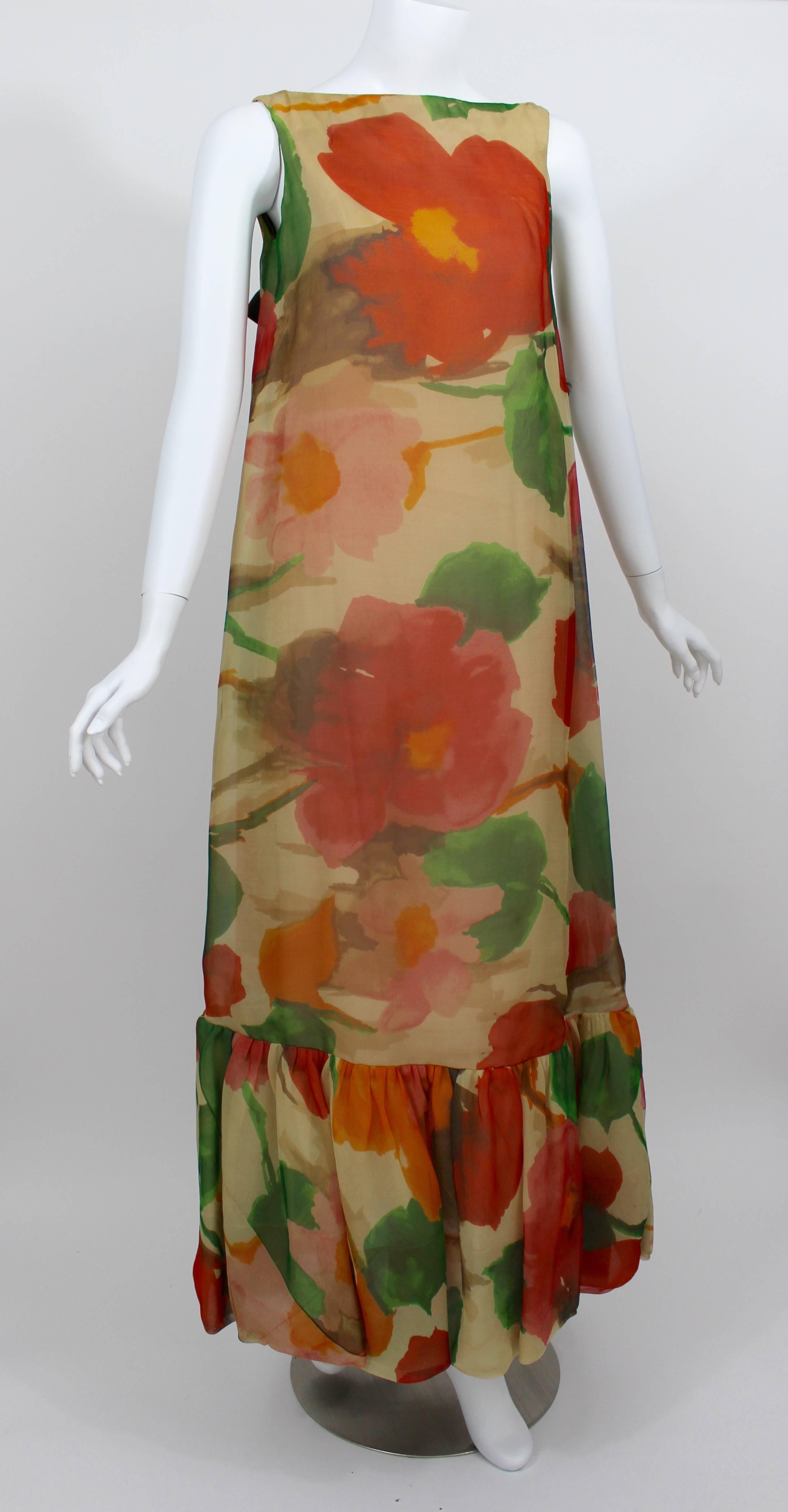 A stunning organza watercolor floral print dress. The back is detailed with two chocolate brown satin bows. The designer label was lost along the way, the Martha palm beach label remains. 
Fully lined. Closes in the back with a 10