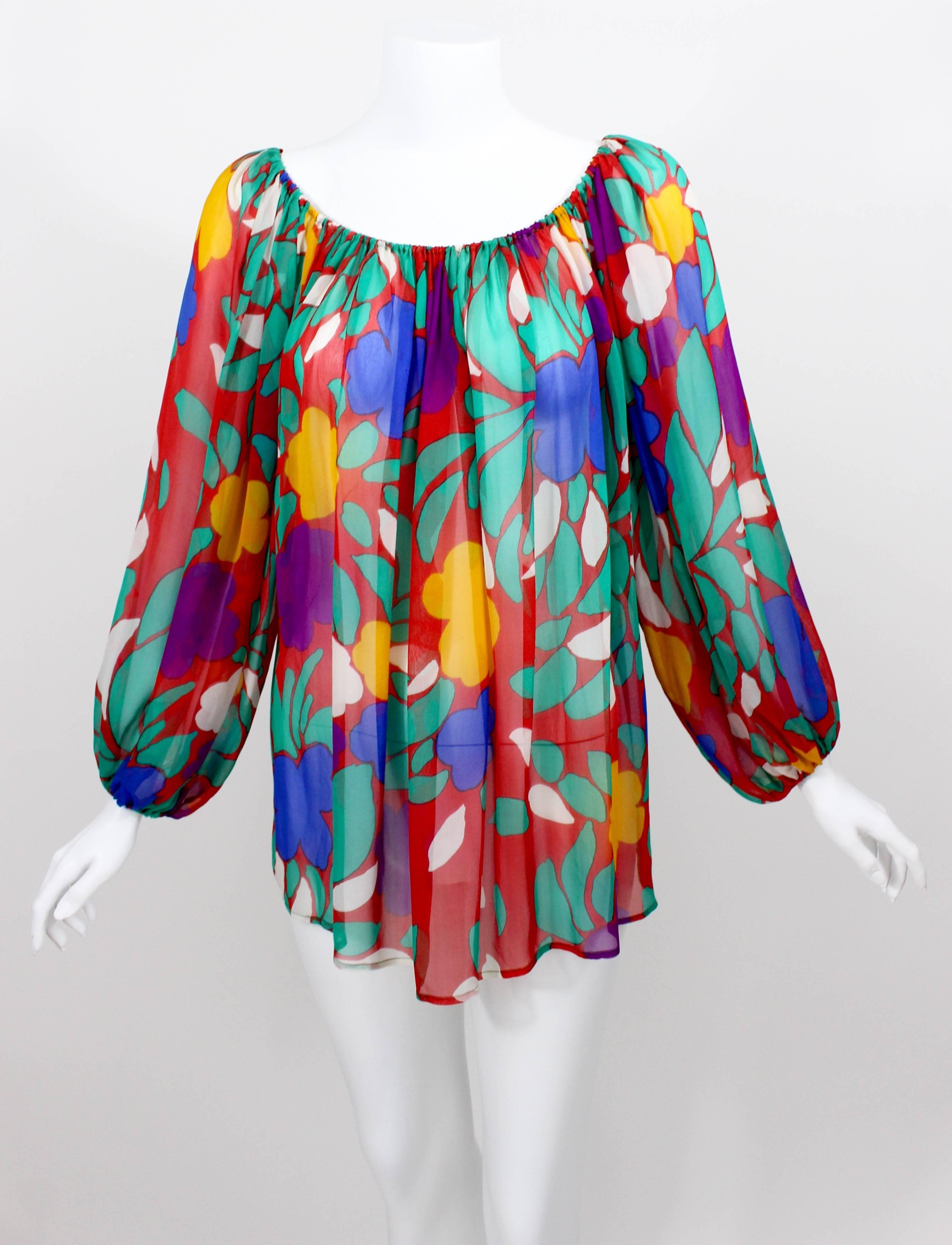 A print of tropical flowers in vibrant Pop Art colors makes this silk chiffon blouse designed by Yves Saint Laurent an amazing vintage find. Part of his spring/summer 1979 collection, it was positively captivating on the runway—a standout piece that