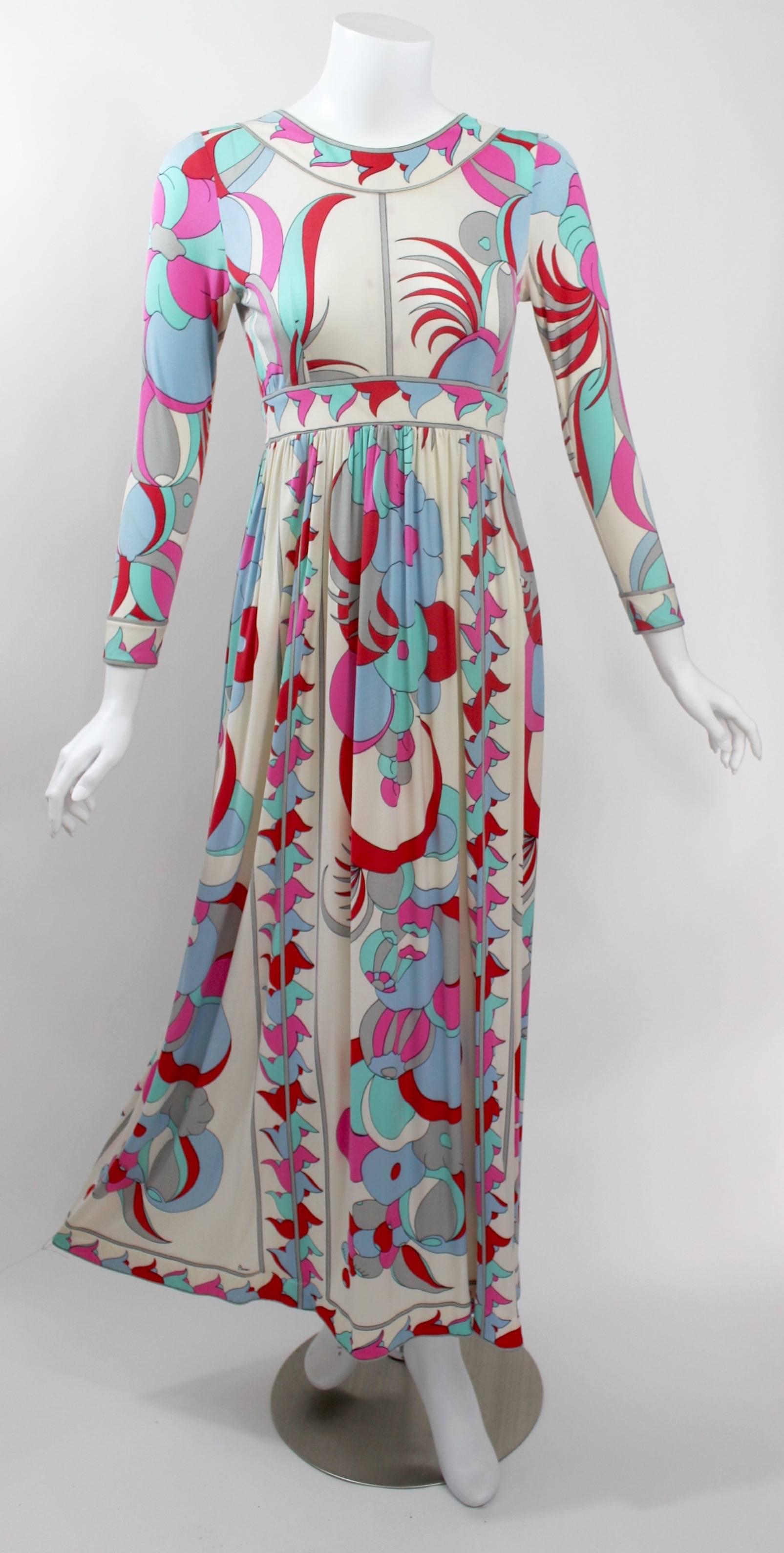A fabulous 1960s Italian silk jersey print dress by Bessi. Long fitted sleeves, Empire waist and a long full skirt. 
Contrasting border print around the neckline waist, sleeves and hem.
Unlined and closes with a painted back metal zipper. 
Excellent