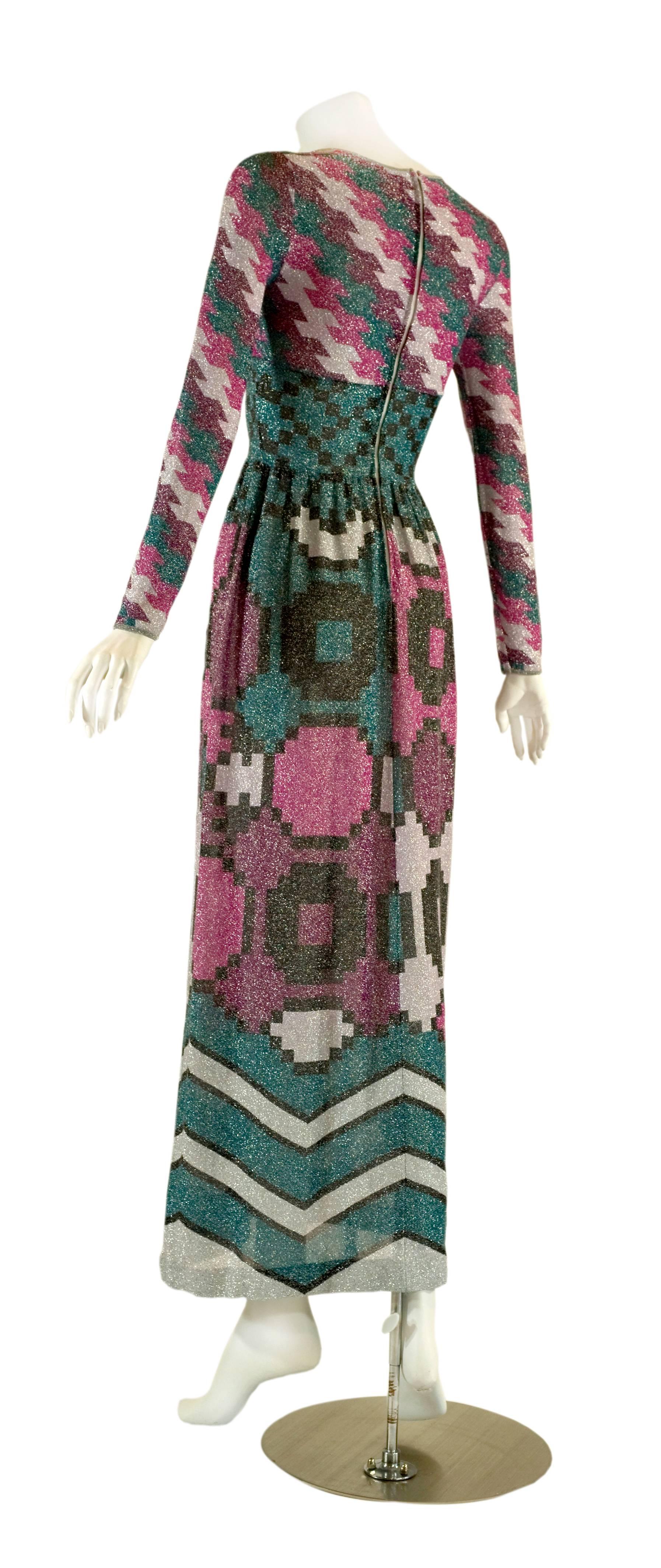 This is a fantastic vintage Lanvin dress done in a lightweight metallic knit. I love the colors and the graphic print. A brilliant mix of raspberry, pink, teal, silver and black, worked into four different prints that flow into each other. The