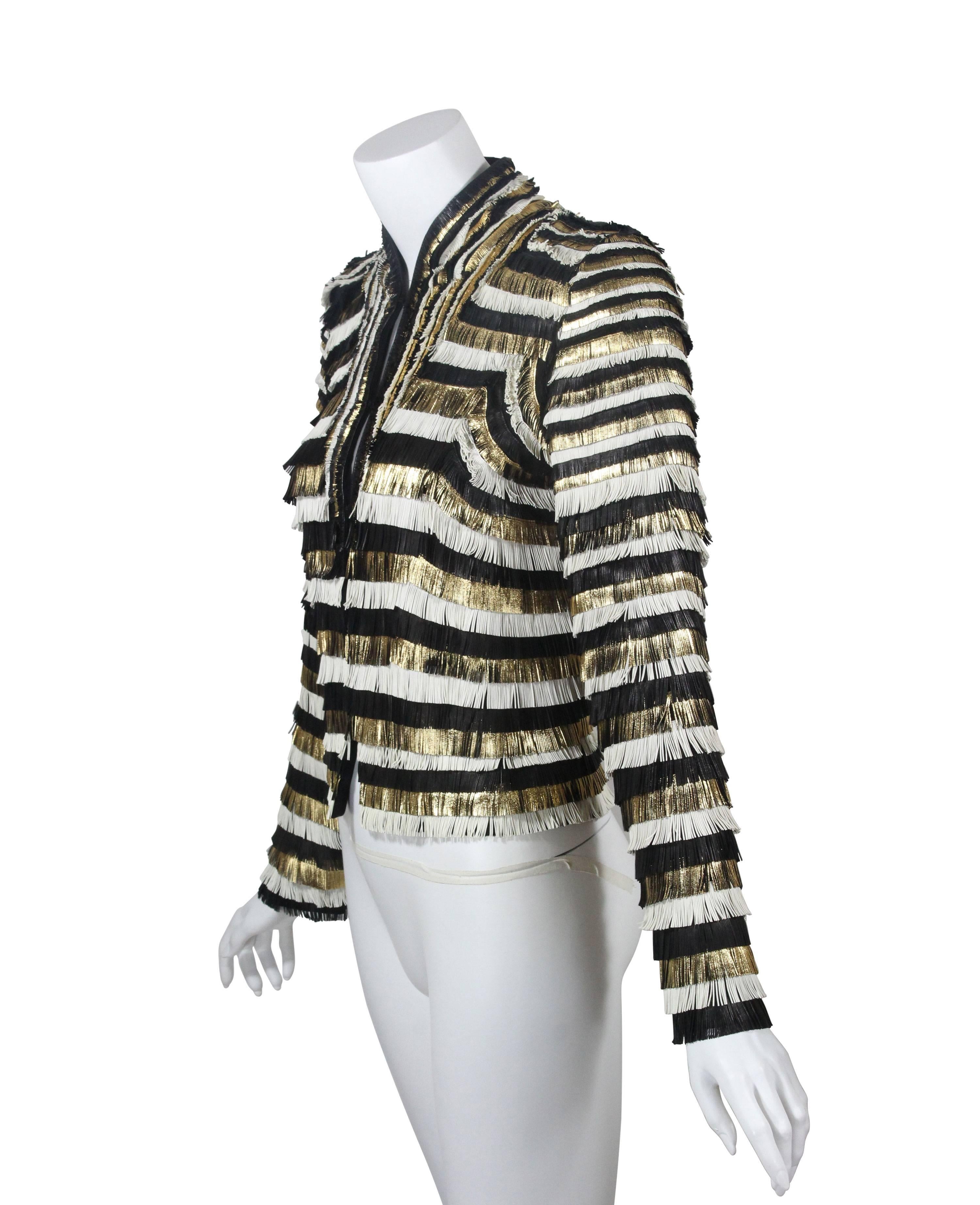 An incredible Gucci leather jacket. The entire jacket is done in rows of fine fringe leather in black, metallic gold and white  sewn onto silk.  The fringe varies from micro length at the top of the shoulders and gets slightly longer layer by layer