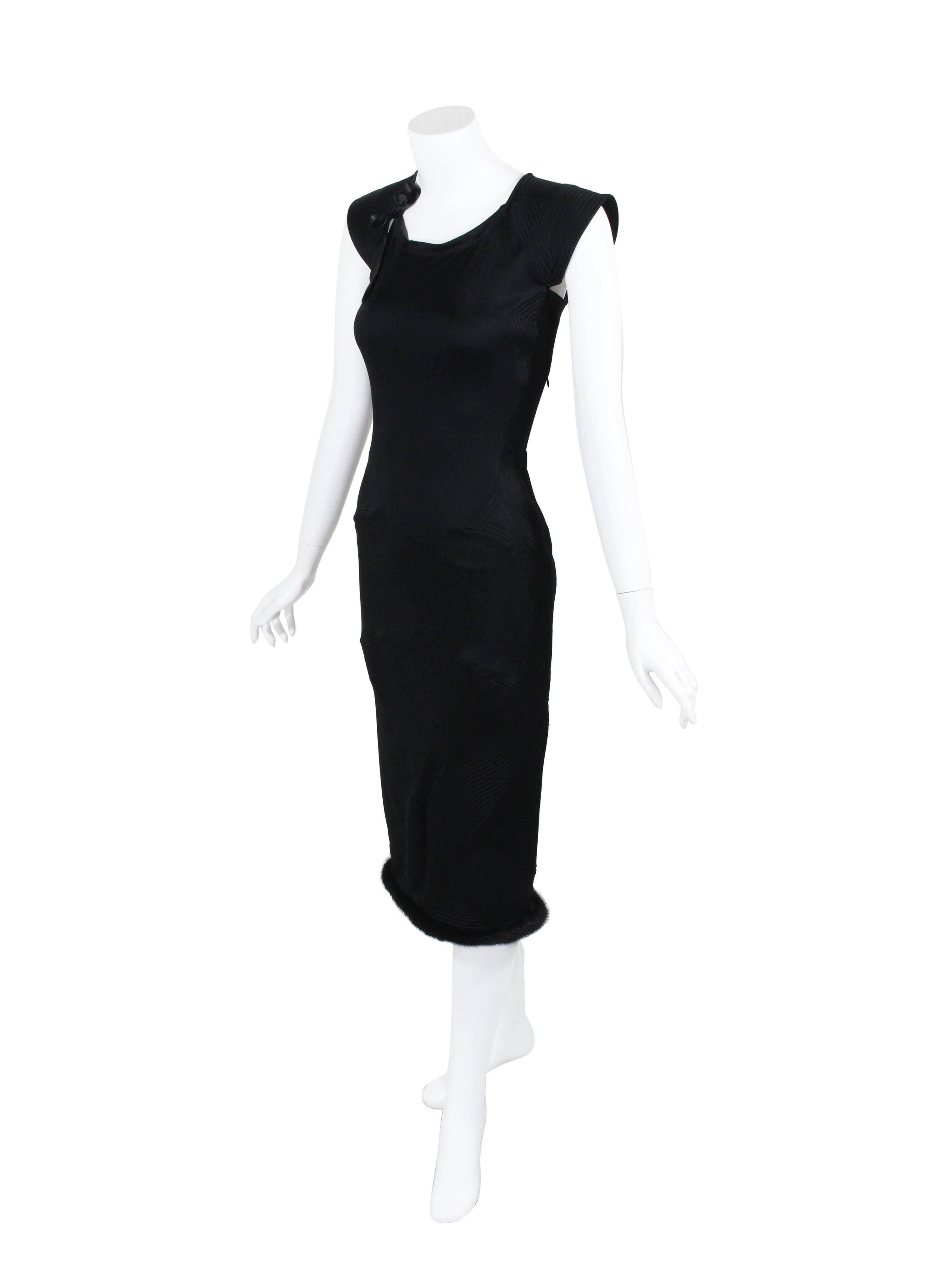 An Yves saint Laurent dress by Tom Ford from his final and most memorable collection for the house. Done in a luxurious jet black silk jersey with beautiful detail work of trapunto stitching designs. A silk ribbon at the neckline and finished at the