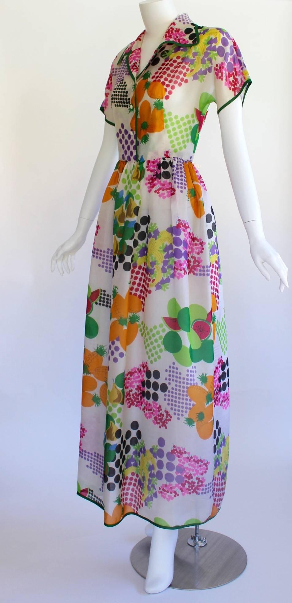 Pop Art meets pretty in this vintage Nina Ricci Boutique dress. Cut from an absolutely delicious print of Ben-Day dots, graphic fruits and romantic flowers in a riot of sumptuous hues, it references all the best of Roy Lichtenstein, Marimekko and