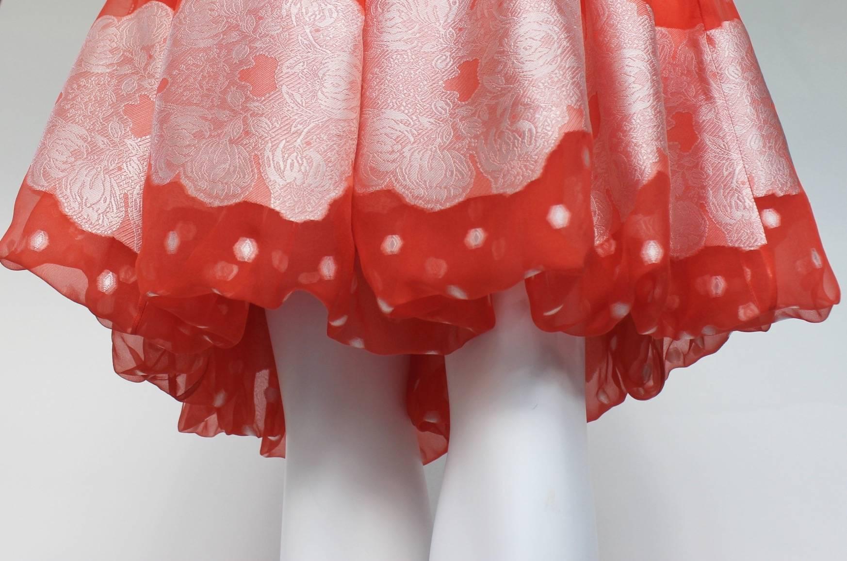 Sweet daydreams are made of this: a light-as-air skirt by Nina Ricci. Stitched together from lengths of tangerine silk, the gored construction is tucked under at the hem to add extra buoyancy to the silhouette. Then as if the wearer had strolled