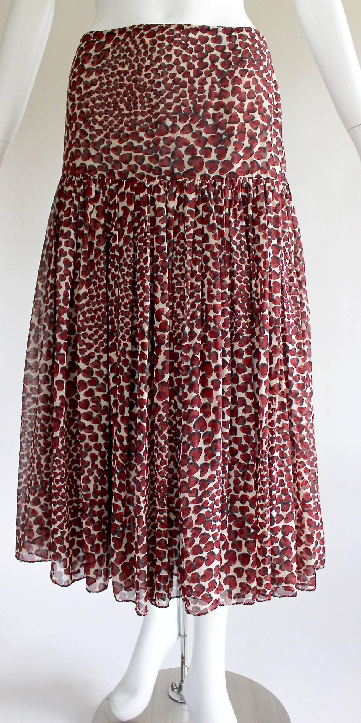 It’s easy to fall for hearts, especially these ones designed by Miuccia Prada. They dot a cream background like spots on a wild animal’s coat, forming a signature print that is both adorably sweet and incredibly seductive. Appearing on the