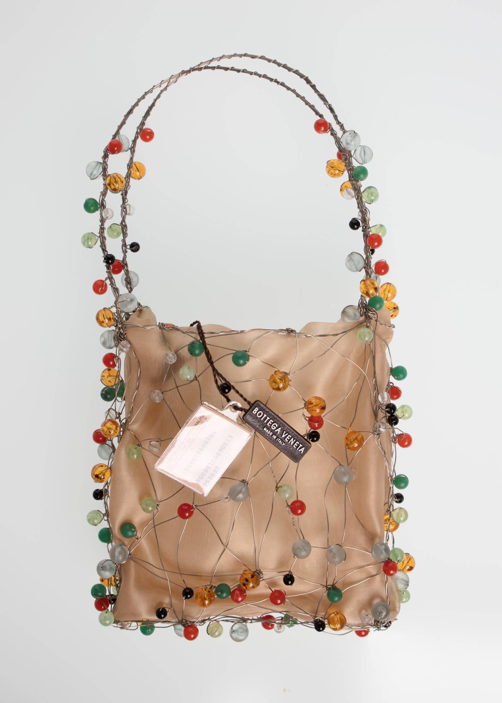 Beaded handbags were all the rage for much of the 19th century.  Called reticules, these small bags would carry only the barest of necessities and tended to be more of a decorative accessory than functional. This contemporary version by Bottega