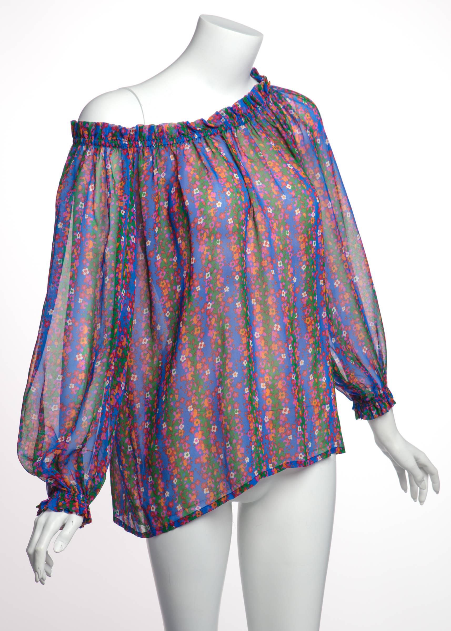 Yves Saint Laurent dominated the runway during the 1970s. His bohemian-chic styles delighted those who had waning interest in the sharp lines of 1960s mod fashion. This silk chiffon blouse features a dense print of blue and green vertical stripes