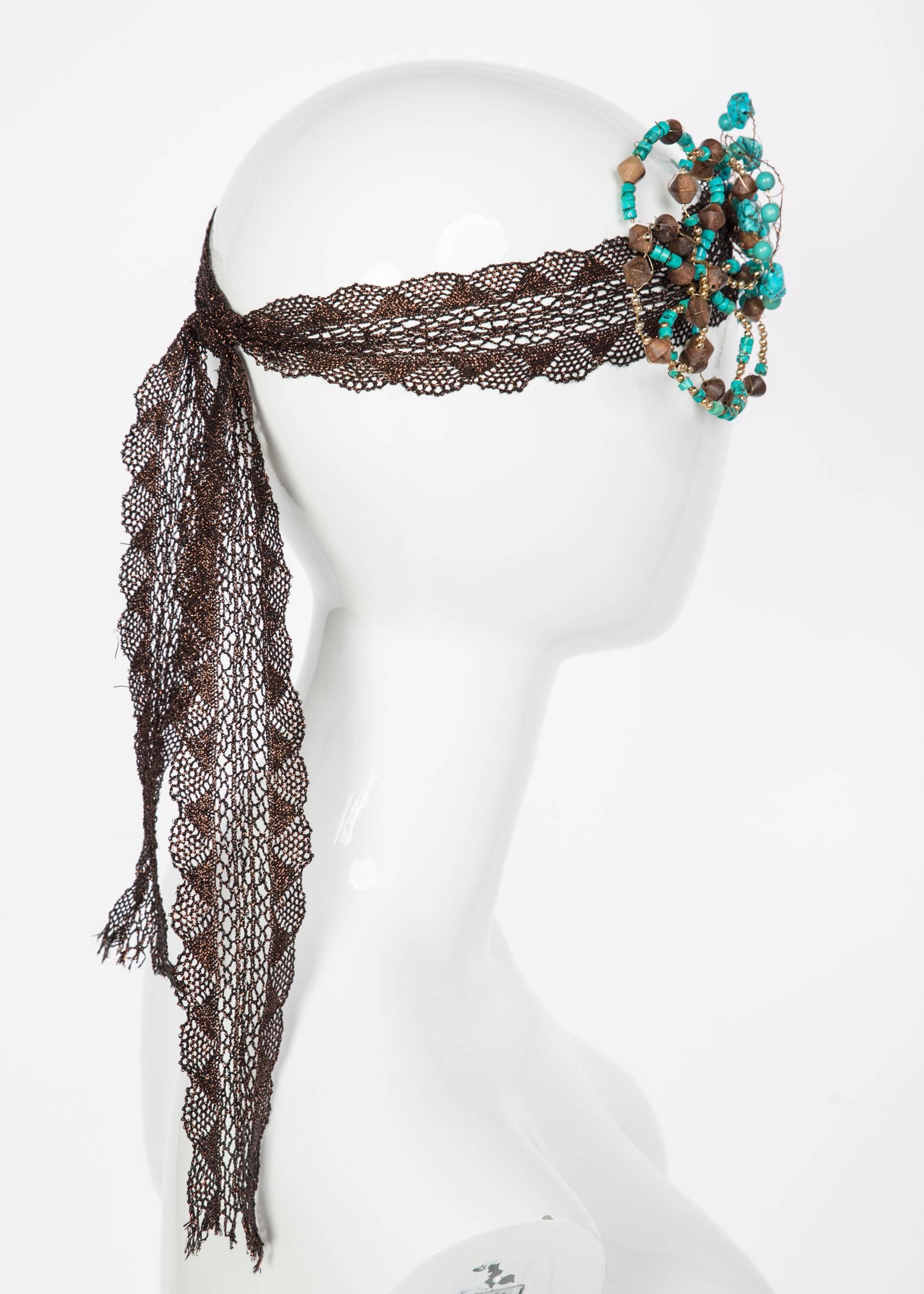 Flowers sculpted from metal wires beaded with turquoise and wood beads. Hand sewn on to antique copper lace ribbon. 

Measurements:
Lenghth: 45 inches
Flowers are approximately  4 inches in diameter for the larger one and the smaller measures 3