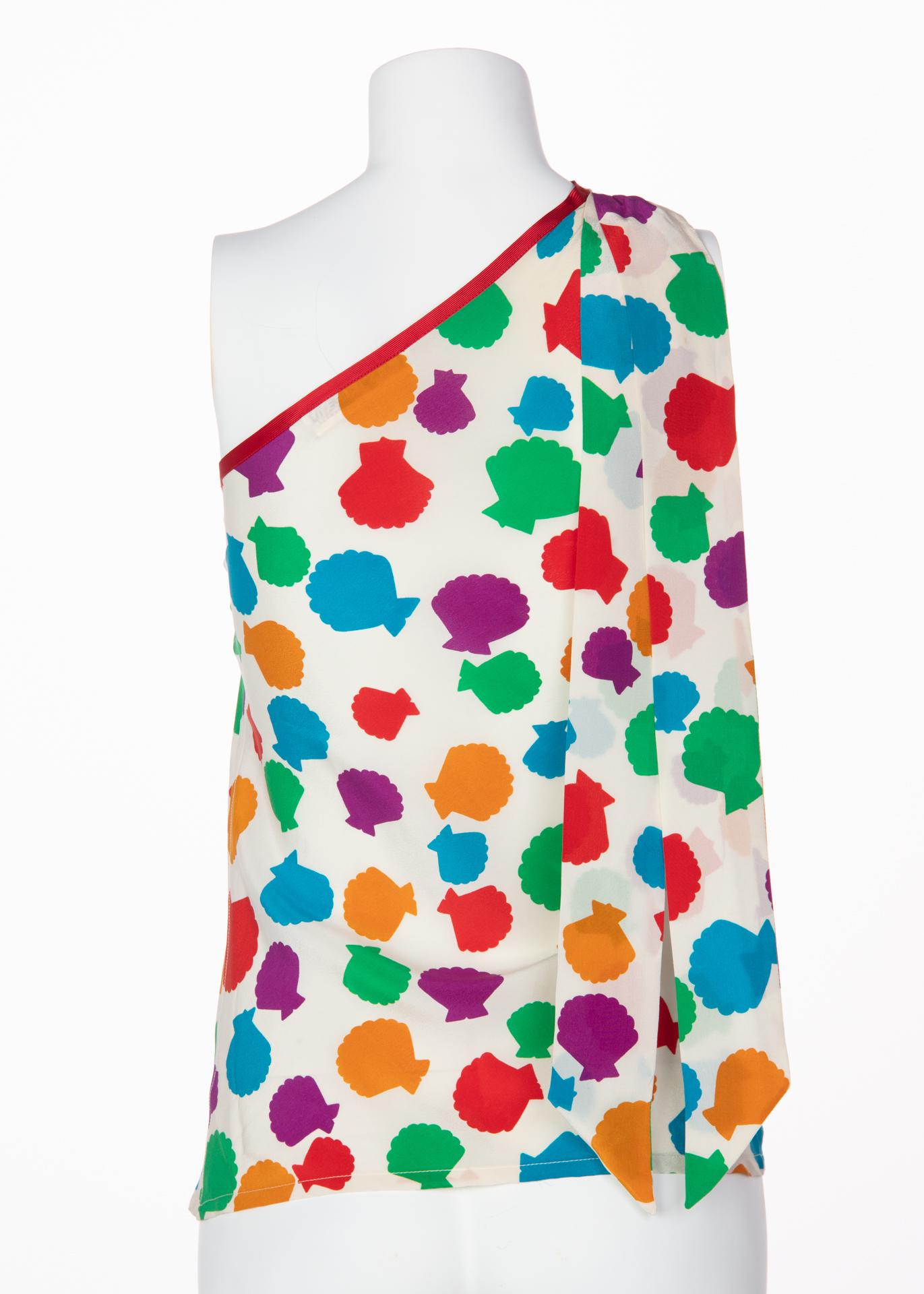 Among various influences and inspirations, pop-art stylings frequent many YSL designs. His affinity for eccentric prints and quirky color combinations ensured a jovial mood to his garments. Circa the mid-1970s, this one-shoulder blouse dons a