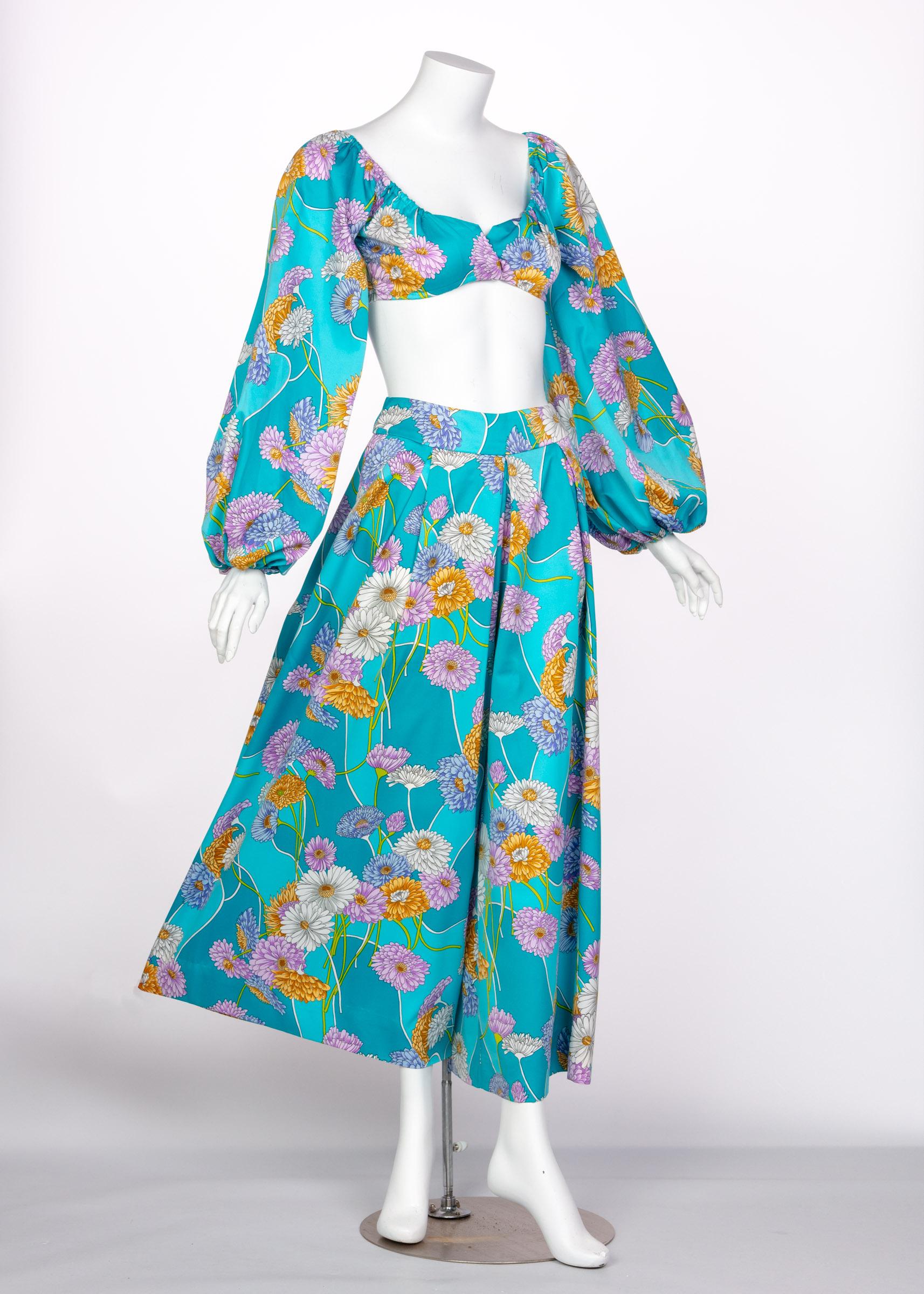 Rife with a variety of styles and cultural influences, the 1970s were filled with flamboyant and playful colors and styles. With growing social movements, two-piece ensembles became increasingly stylish for women. A bold turquoise satin creates this