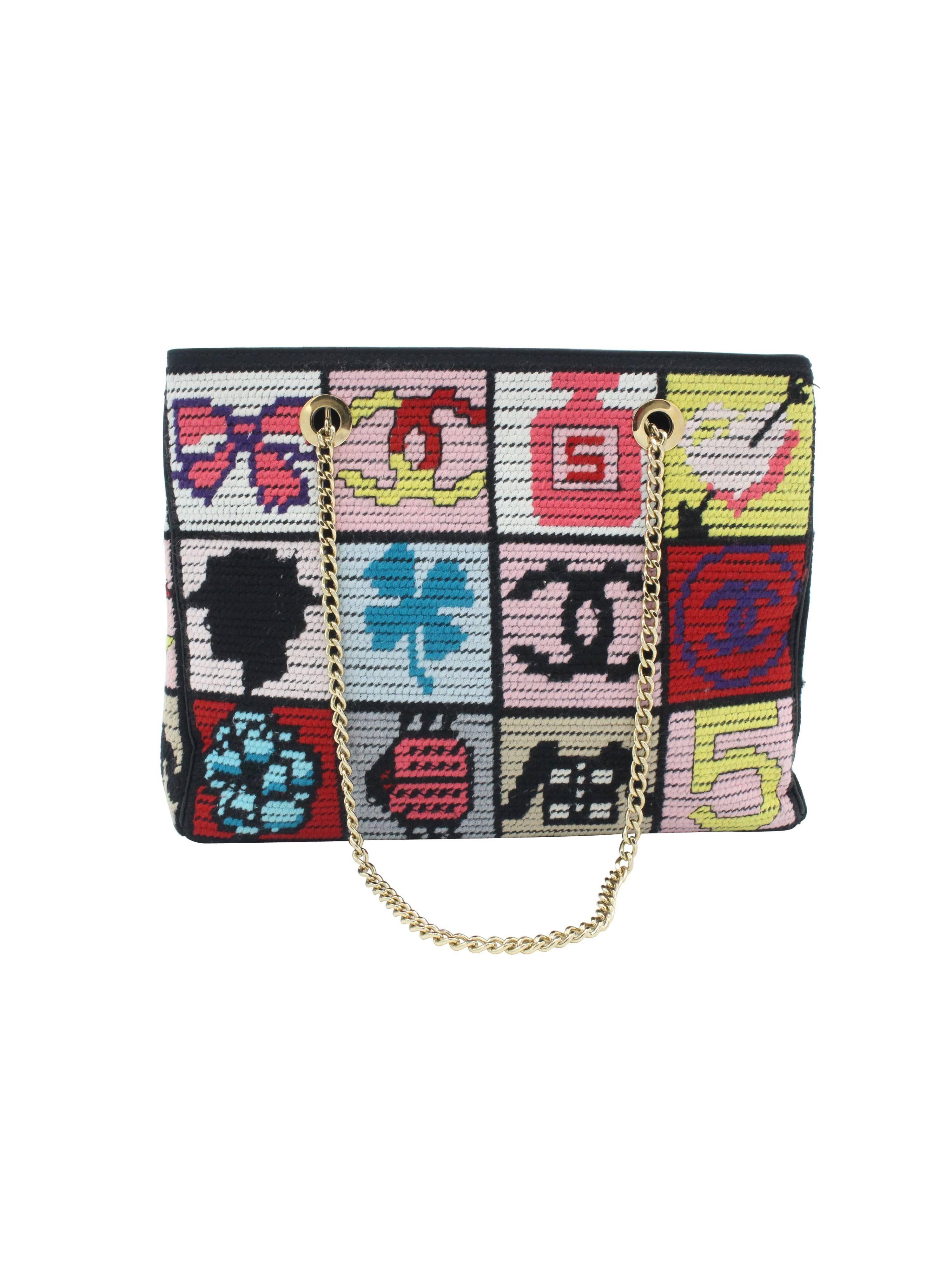 Iconic and hard-to-find limited edition Chanel needlepoint shoulder bag circa 2003. Featuring all the iconic Chanel lucky symbols done in needle point and accented with black lambskin leather. Signature gold tone interlocking   chain strap with the