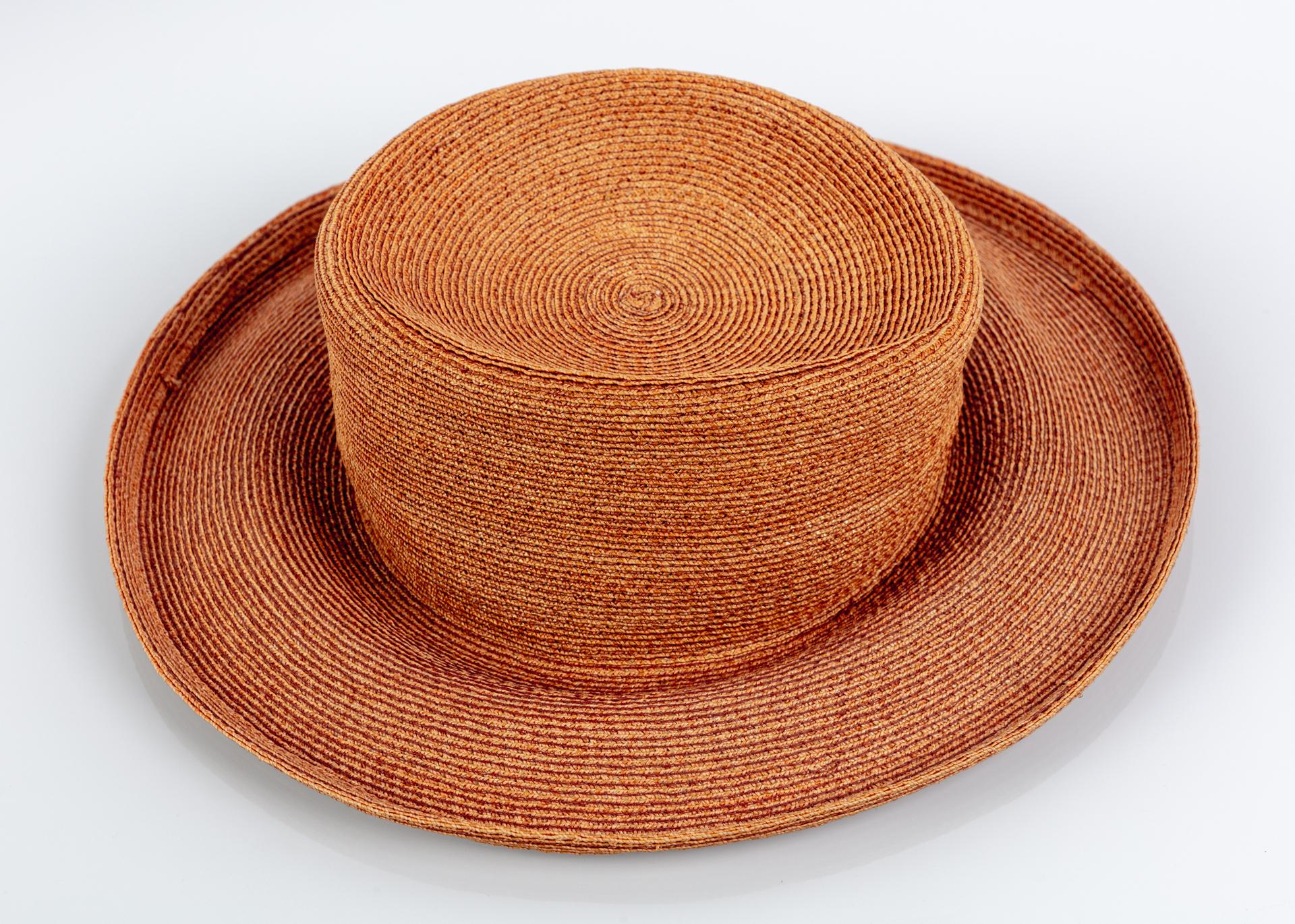This is a classic and woven straw floppy hat made by renowned New York hat designer Patricia Underwood. Done in a gold brown woven straw with a rolled floppy brim. With its flawless construction, this hat is one of those brilliant designs that looks