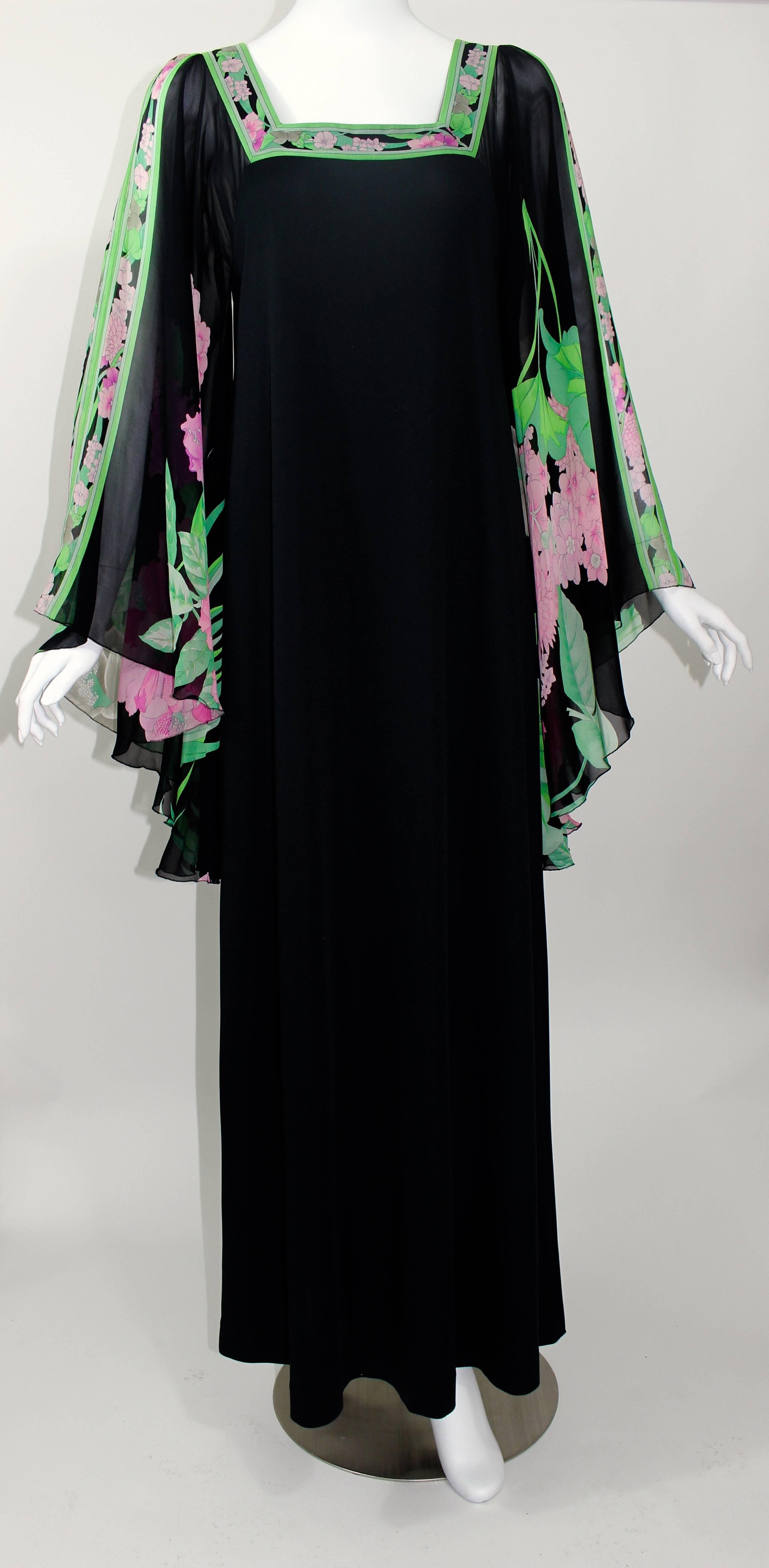 This is a fabulous 1970s Leonard Paris caftan style maxi dress. 
The body of the dress is in black jersey ,  with the square neckline trimmed in silk chiffon, and the beautiful long draped angel sleeves in sheer silk chiffon. 
The back has 3